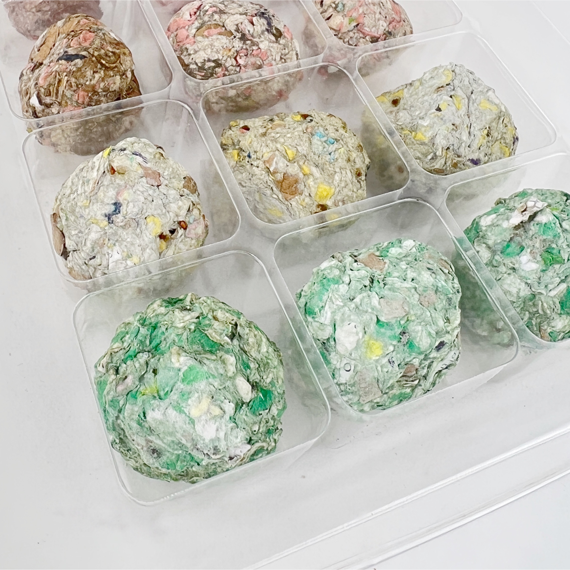 Close-up of handmade multicolored seed balls made with recycled paper and natural clay