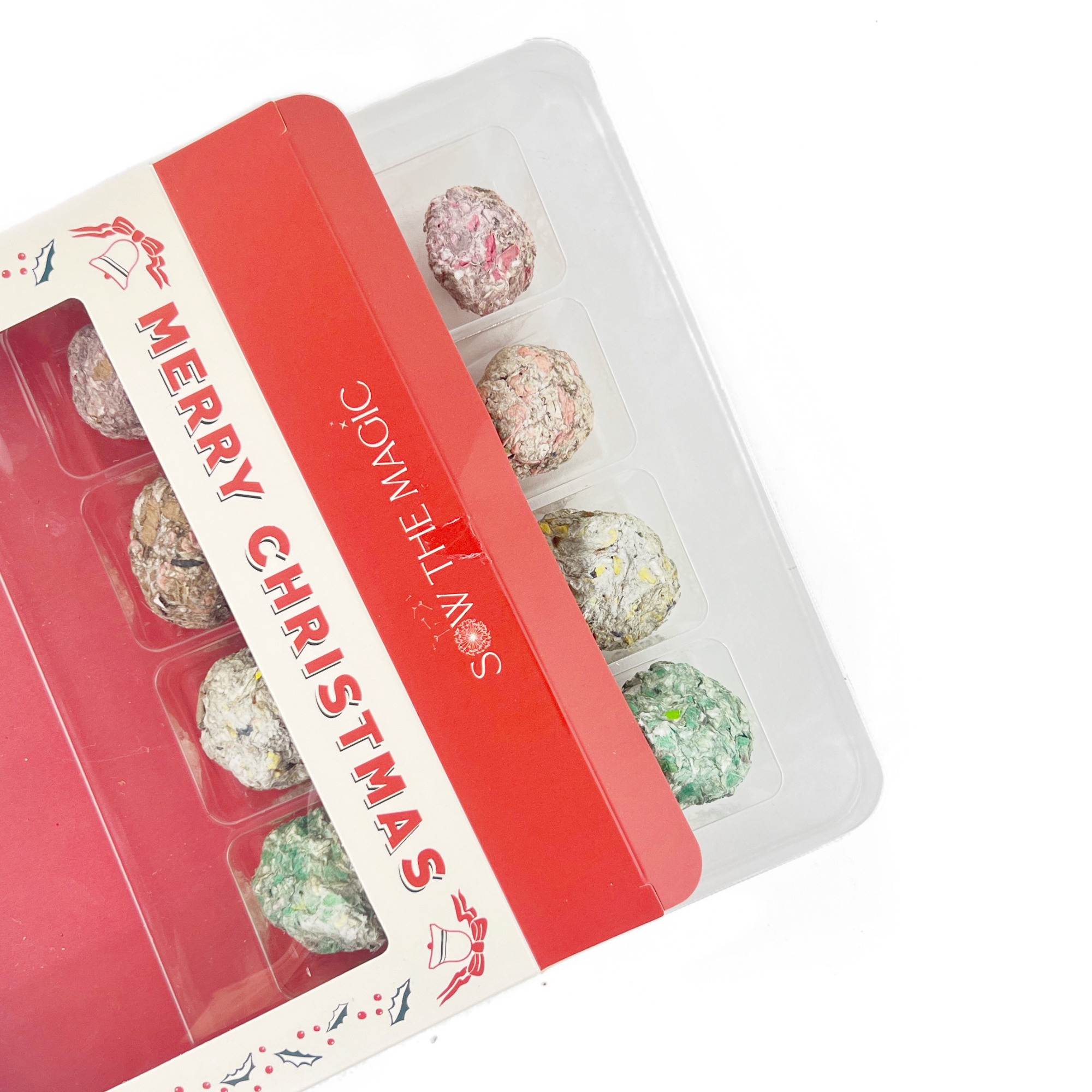 Close-up of eco-friendly Merry Christmas seed ball packaging and handmade planting balls