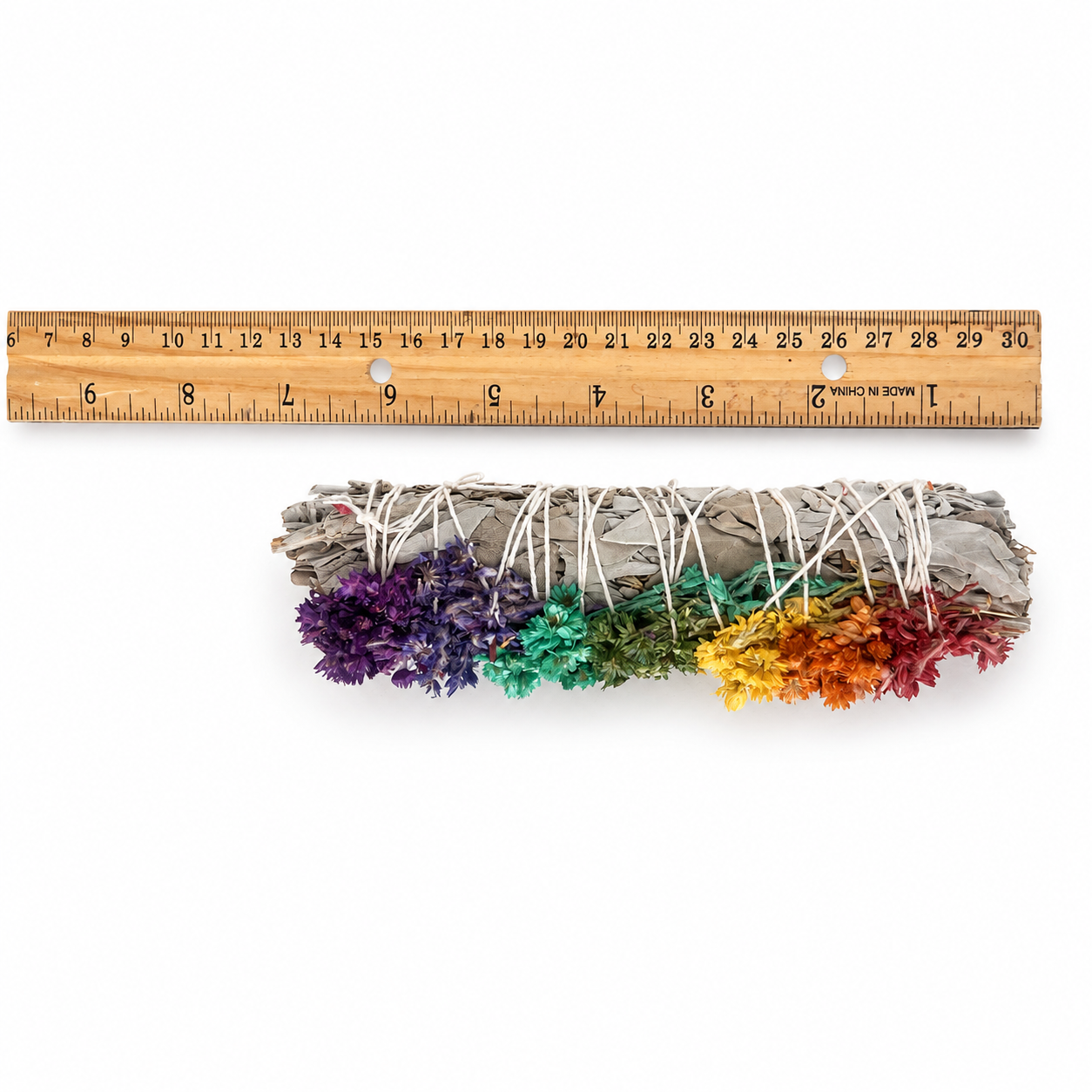 Chakra white sage and colorful sinuata flower smudge stick shown with ruler for 6 inch size reference