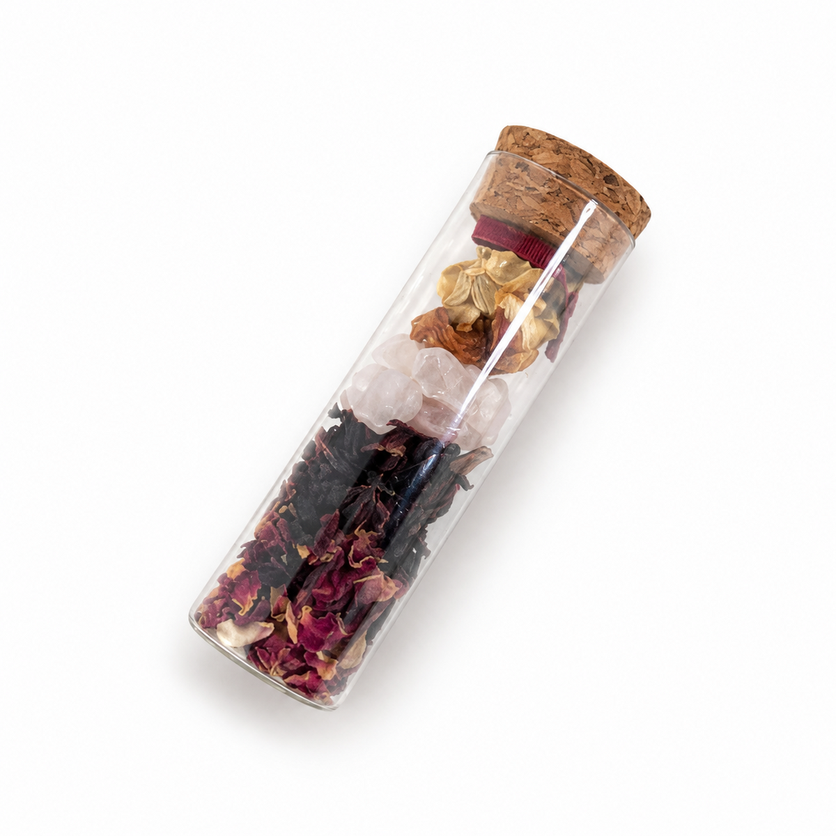 Angled view of a corked A Token of Love vial filled with dried flowers, herbs and symbolic botanical keepsakes.