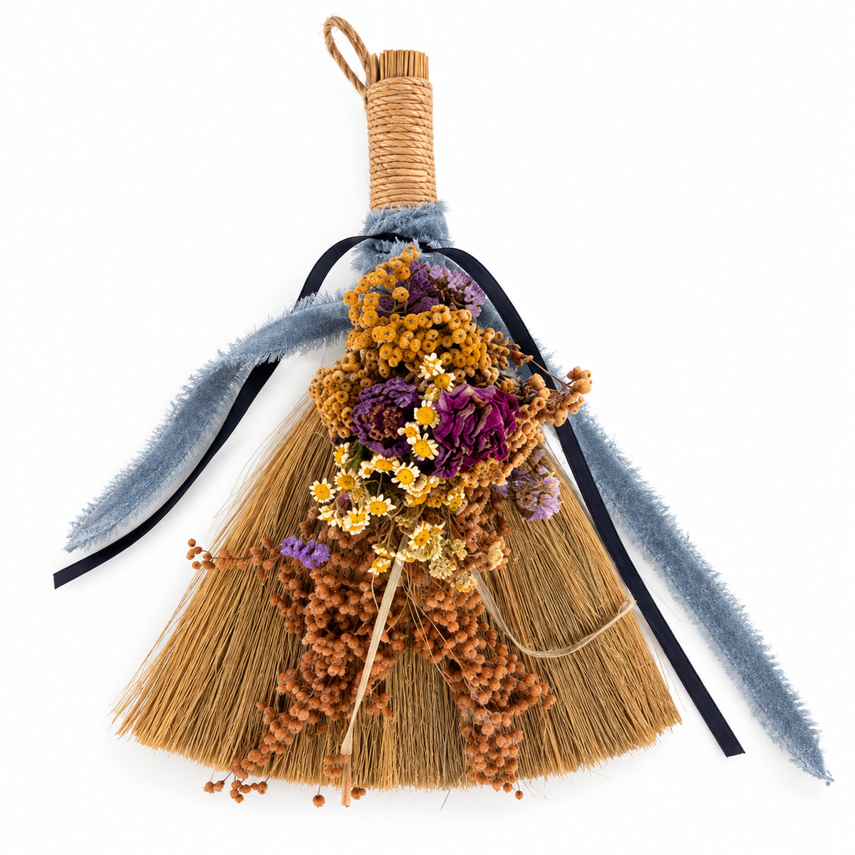 Handmade botanical broom decorated with dried purple flowers, golden botanicals, natural straw, and trailing blue ribbons by Sow the Magic.