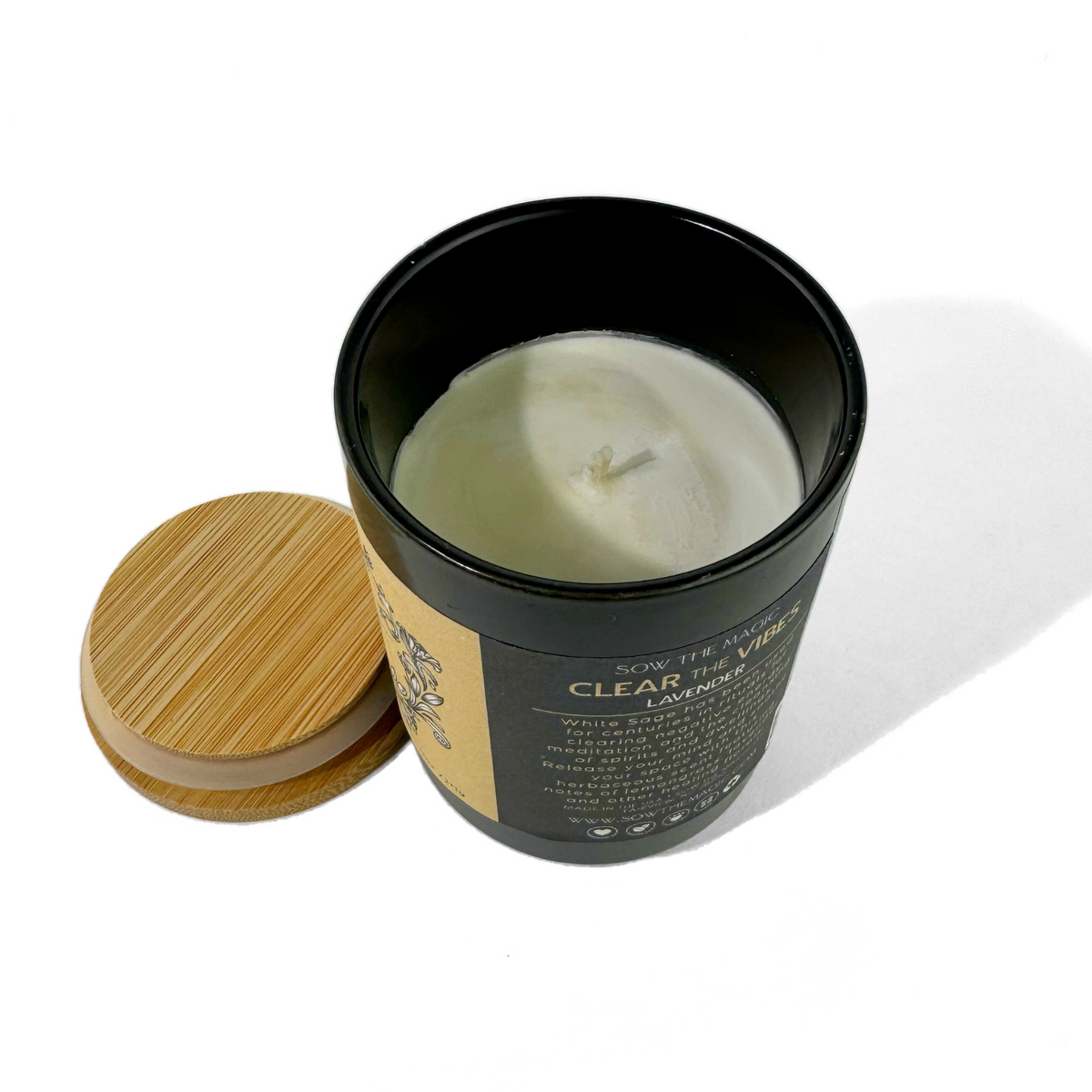 Open Clear the Vibes Lavender candle showing ivory wax and cotton wick with the bamboo lid beside it