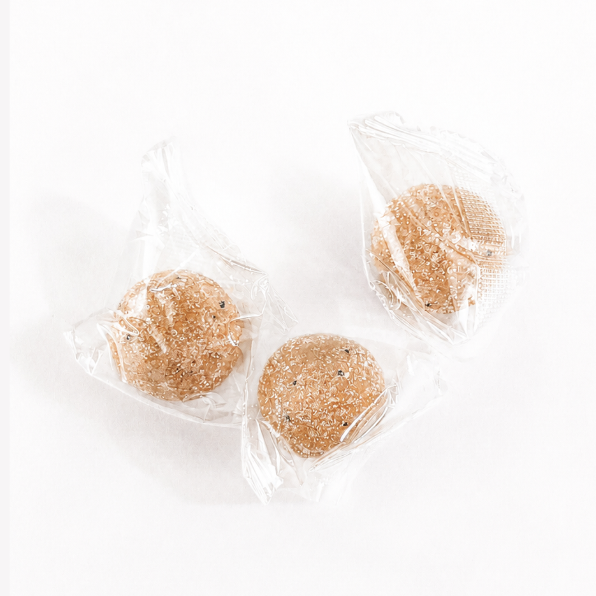 Individually wrapped Coffee Bean Exfoliating Sugar Scrubs made with natural exfoliating ingredients and packaged for gifting.