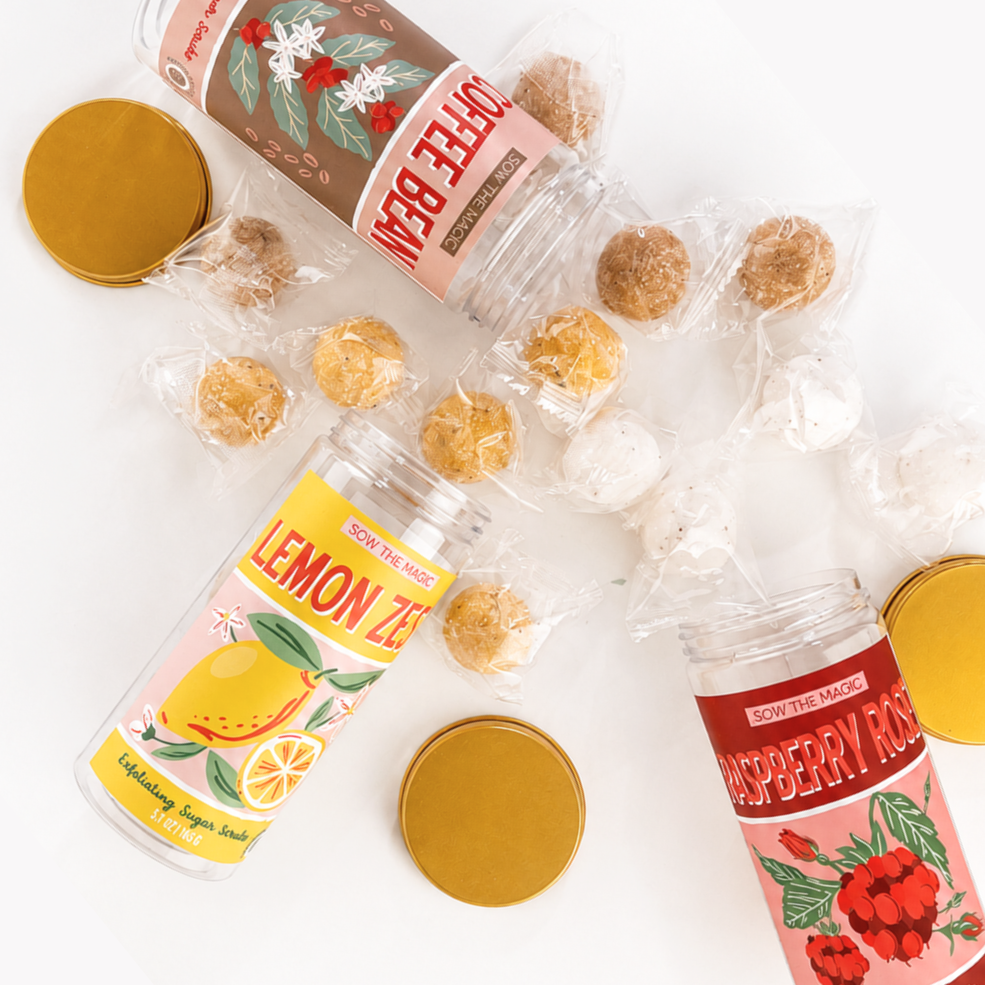 Collection of Coffee Bean, Lemon Zest and Raspberry Rose Exfoliating Sugar Scrubs displayed together in reusable gift jars.