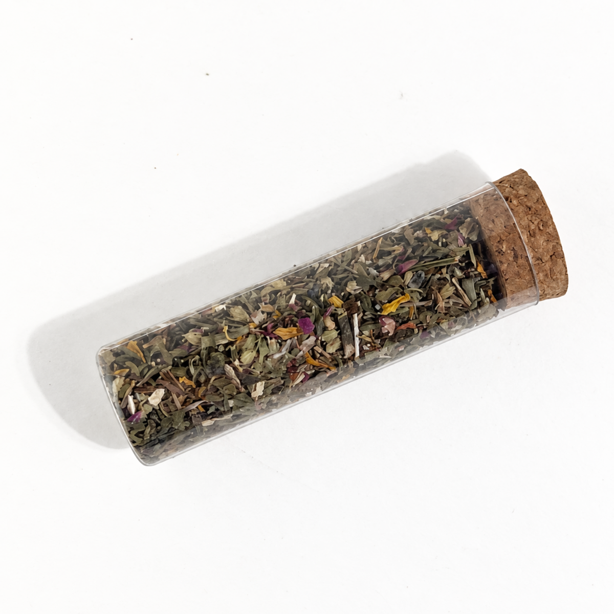 Clear Fairy Wishing Dust intention vial filled with a colorful dried botanical blend on a white background.