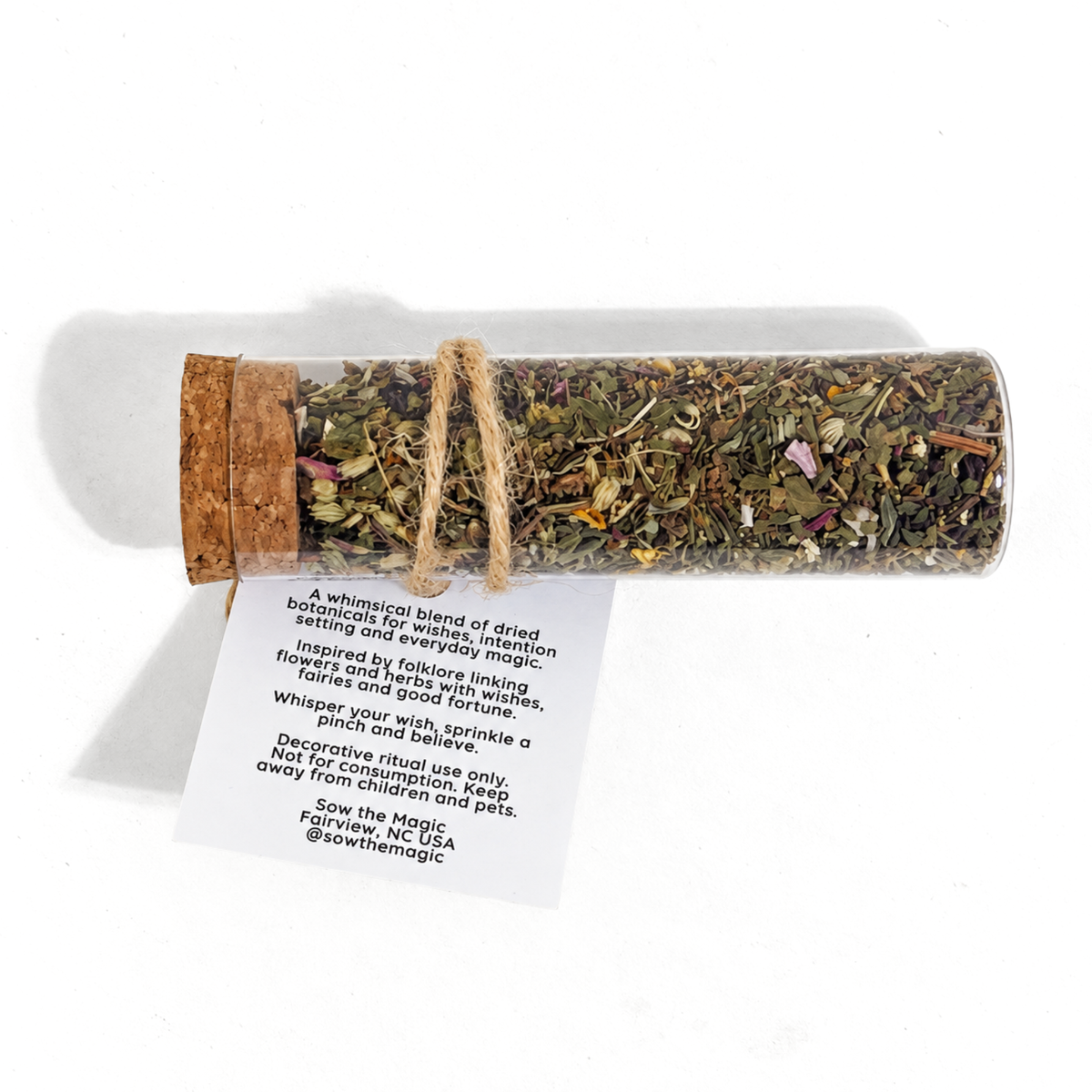 Fairy Wishing Dust botanical intention vial displayed with its printed folklore and ritual instruction tag.