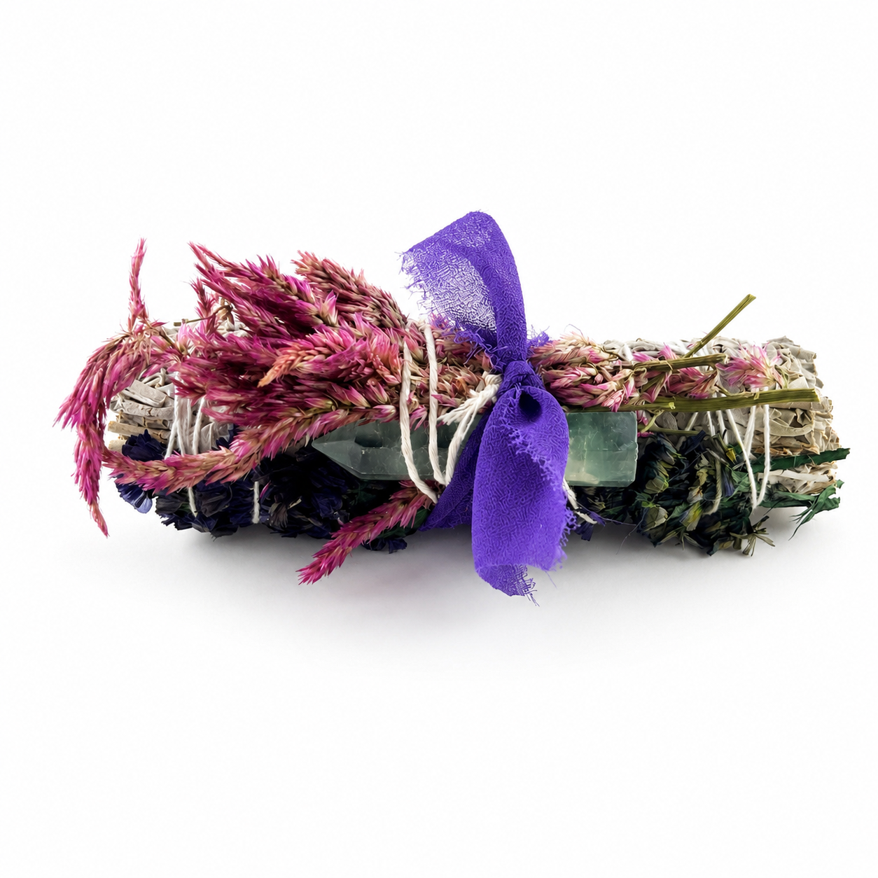 Alt text: White sage bundle decorated with magenta celosia flowers, blue botanicals, a fluorite crystal point and purple ribbon