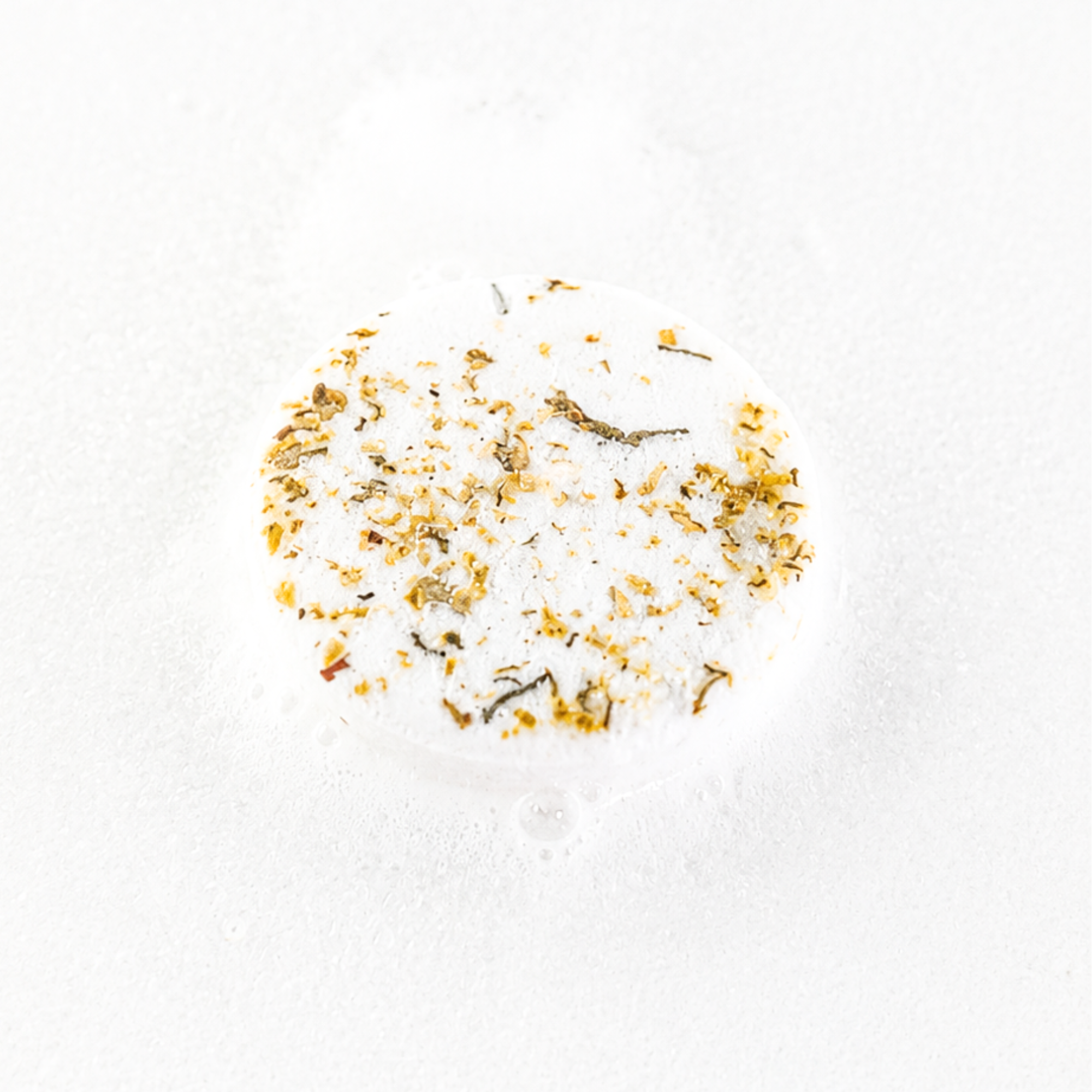 Handcrafted Golden Honey botanical shower steamer decorated with dried flowers and botanicals for aromatherapy showers.