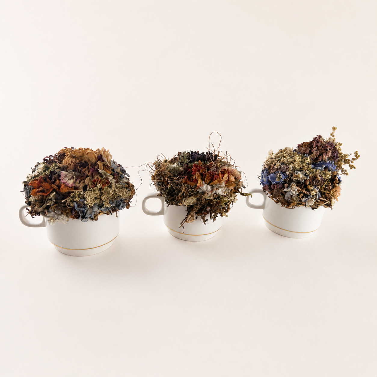 Group of three petite teacup dried flower arrangements handmade with botanicals gathered from the farm.