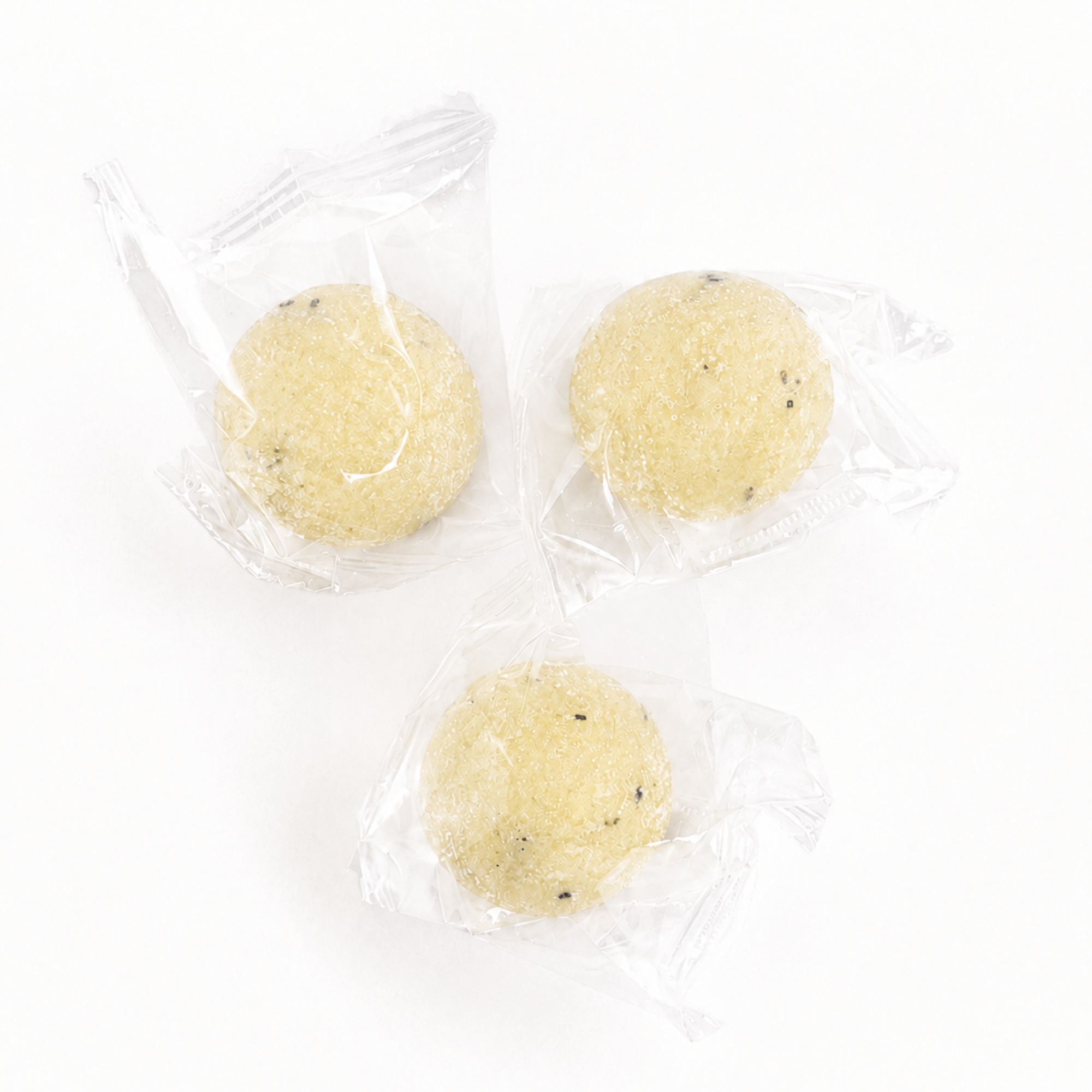 Three individually wrapped Lemon Zest exfoliating sugar scrub cubes with natural exfoliating ingredients for travel, gifts, spa favors and self-care routines.