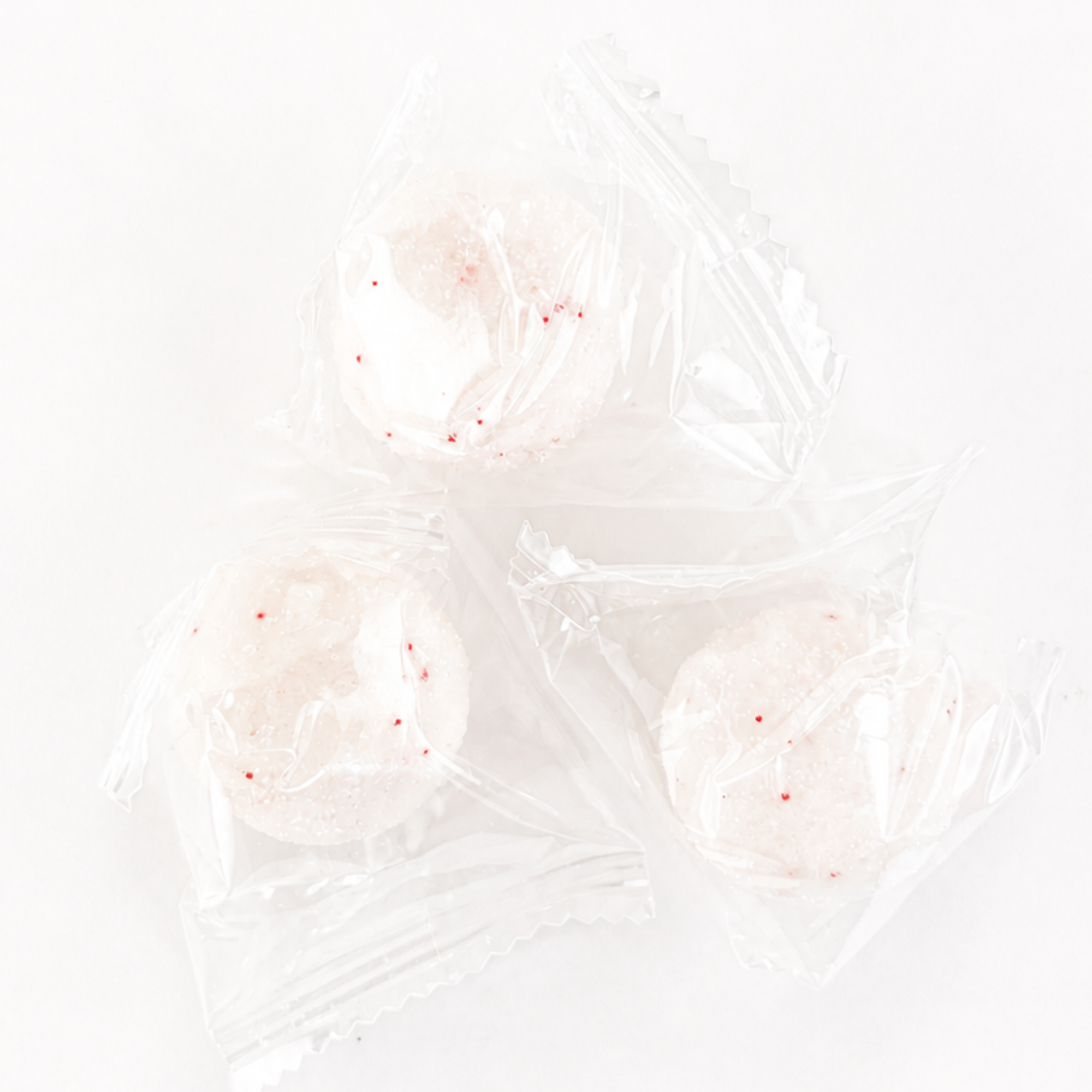 Three individually wrapped Raspberry Rose exfoliating sugar scrub cubes made with natural exfoliating ingredients for smooth, polished skin and convenient travel use.