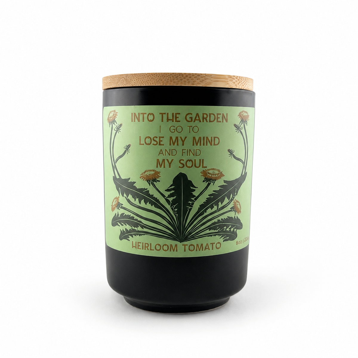 Into the Garden Heirloom Tomato candle in a black jar with a bamboo lid and green botanical label