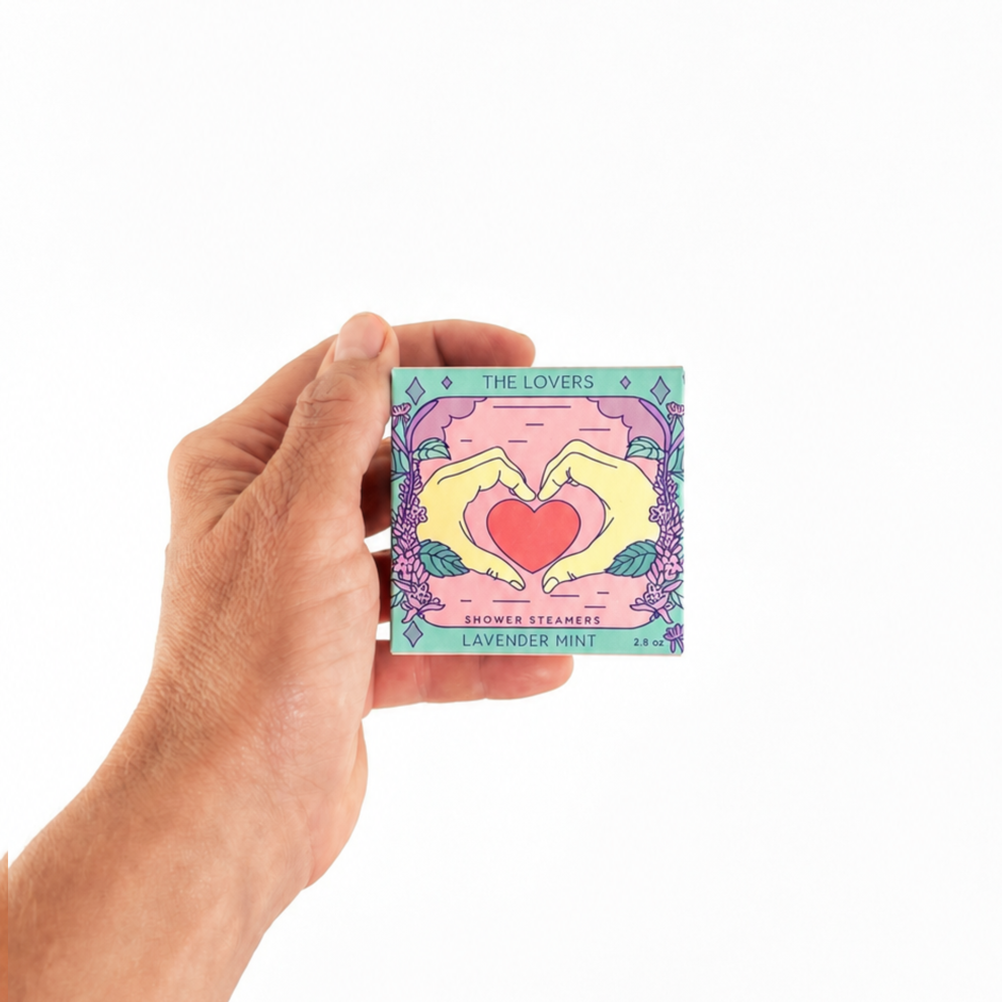 Hand holding The Lovers Shower Steamer Set in Lavender Mint by Sow the Magic® to show the size of the botanical aromatherapy gift set.