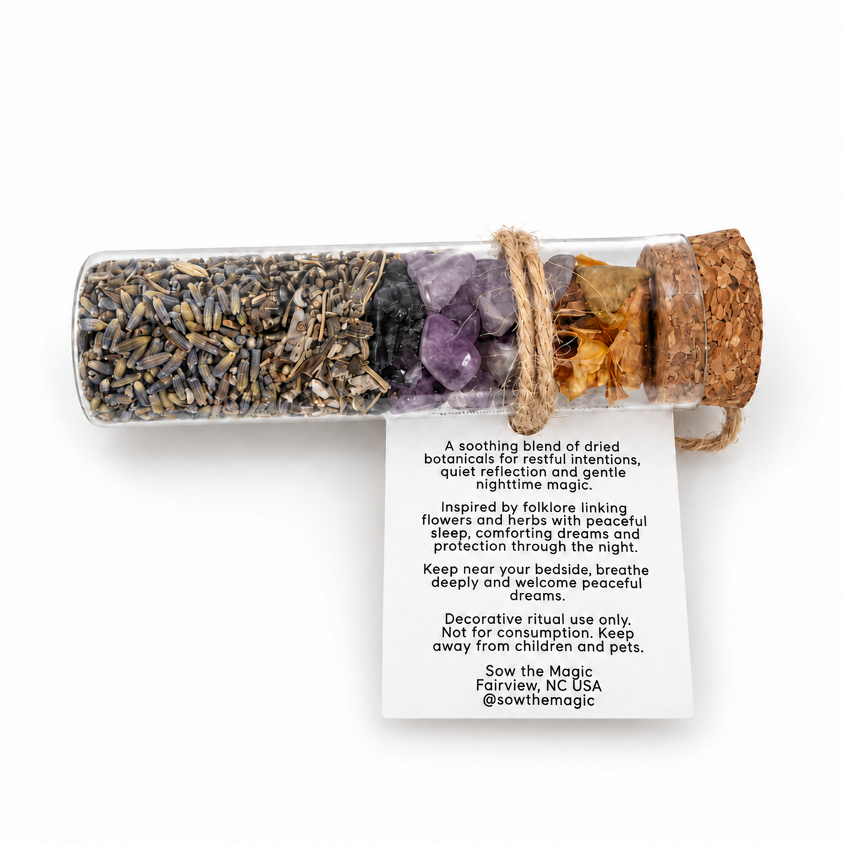 Peaceful Dreams botanical intention vial displayed horizontally with the product details and bedtime ritual instructions visible on the back tag.