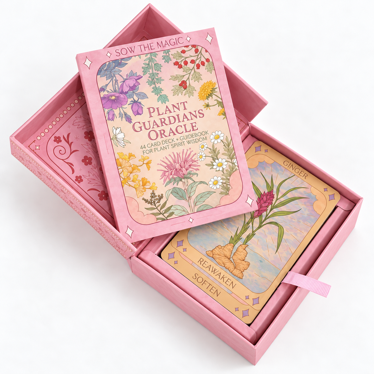 Sow the Magic Plant Guardians Oracle deck displayed in its open pink keepsake box with illustrated botanical guidebook, colorful Ginger oracle card, and ribbon pull tab.