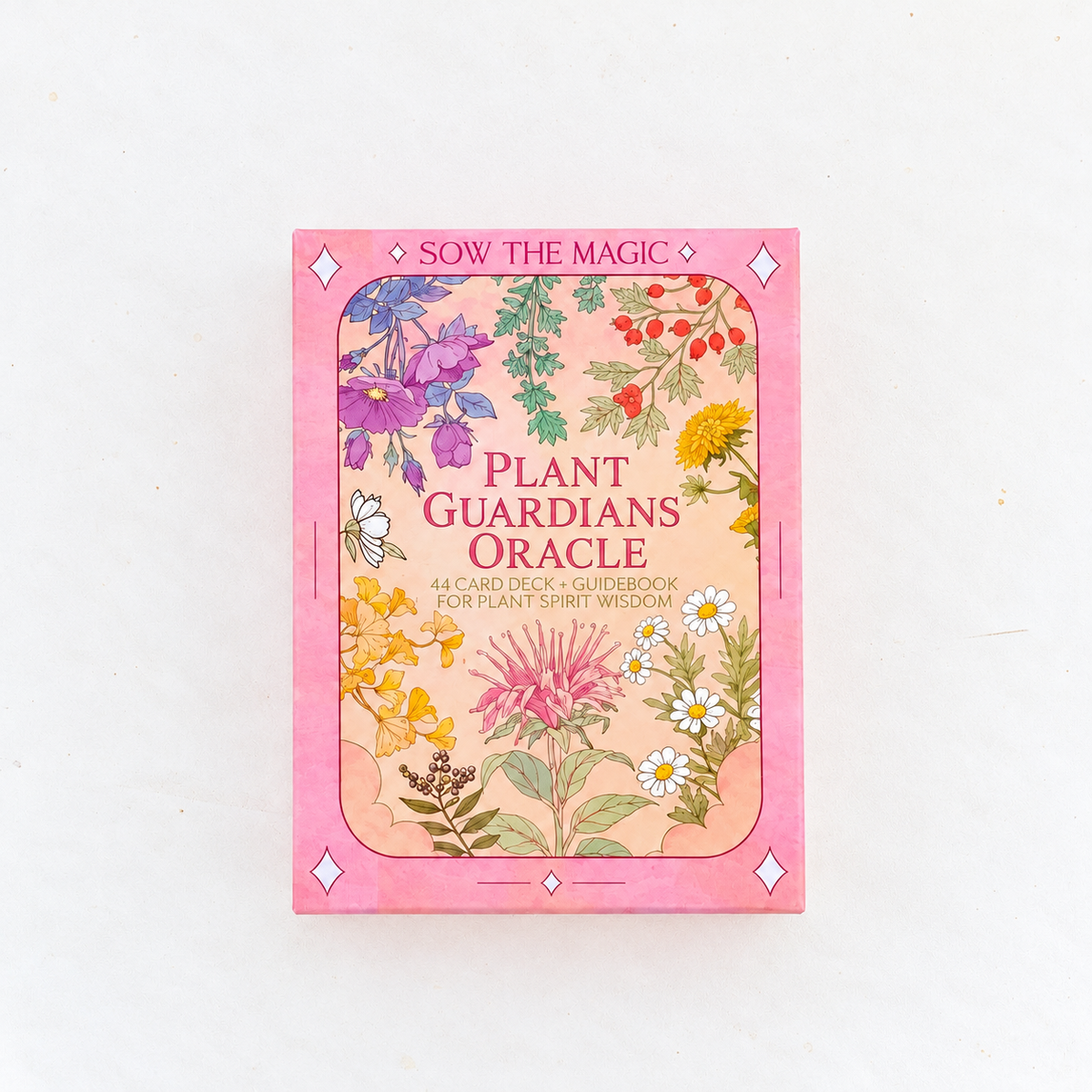 Front view of the Sow the Magic Plant Guardians Oracle deck in its pink floral keepsake box, featuring colorful botanical illustrations and 44 plant spirit cards with an illustrated guidebook.