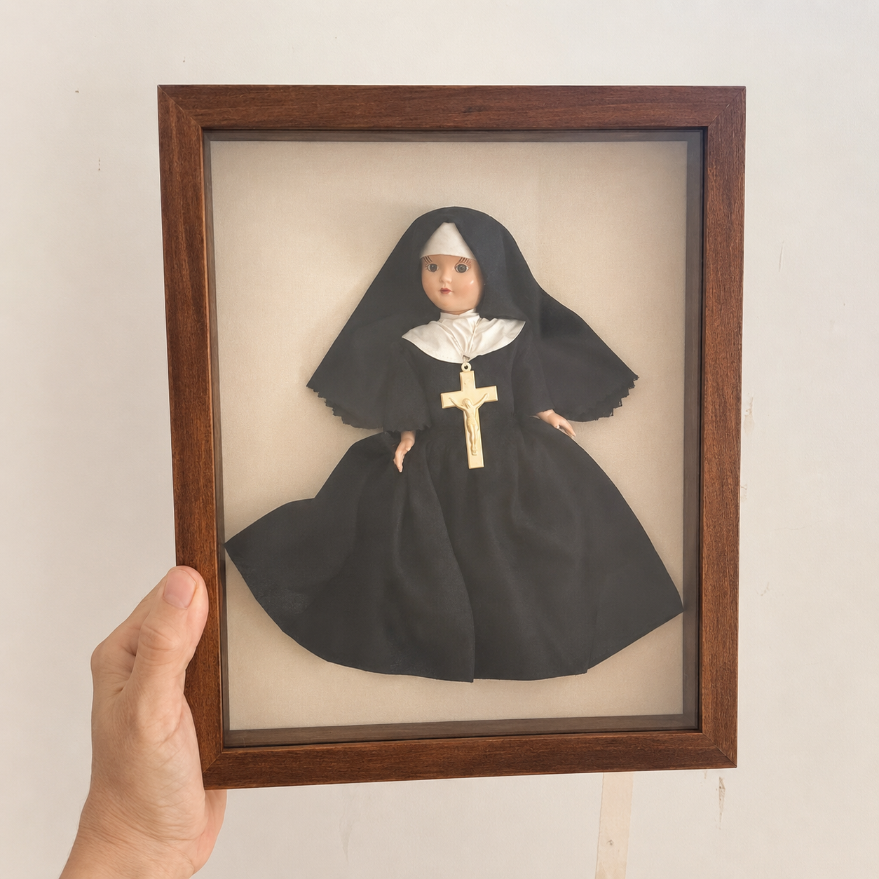 Vintage 1940s nun doll named Sister displayed in a handmade wooden shadowbox frame