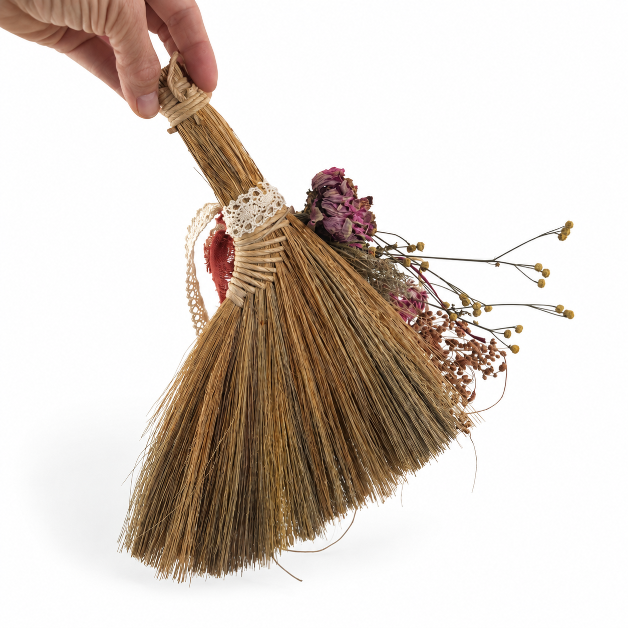 Back view of a handmade decorative broom showing natural broom fibers, wrapped handle and farm-grown dried botanicals.