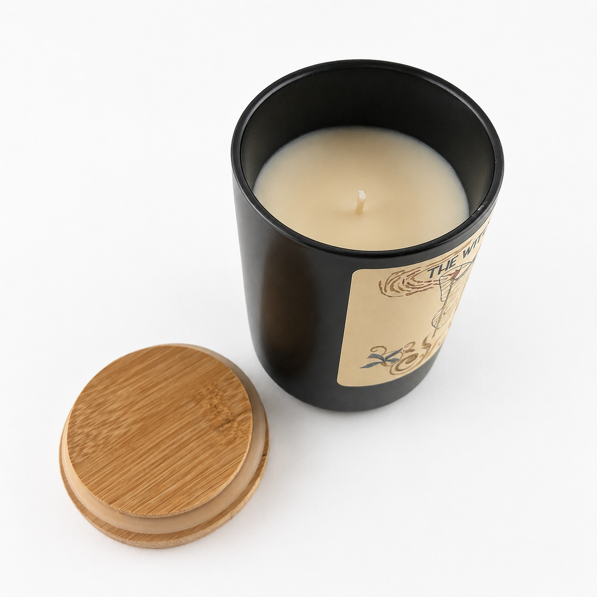 Open Witching Hour Vanilla candle showing ivory wax and cotton wick with the bamboo lid beside it