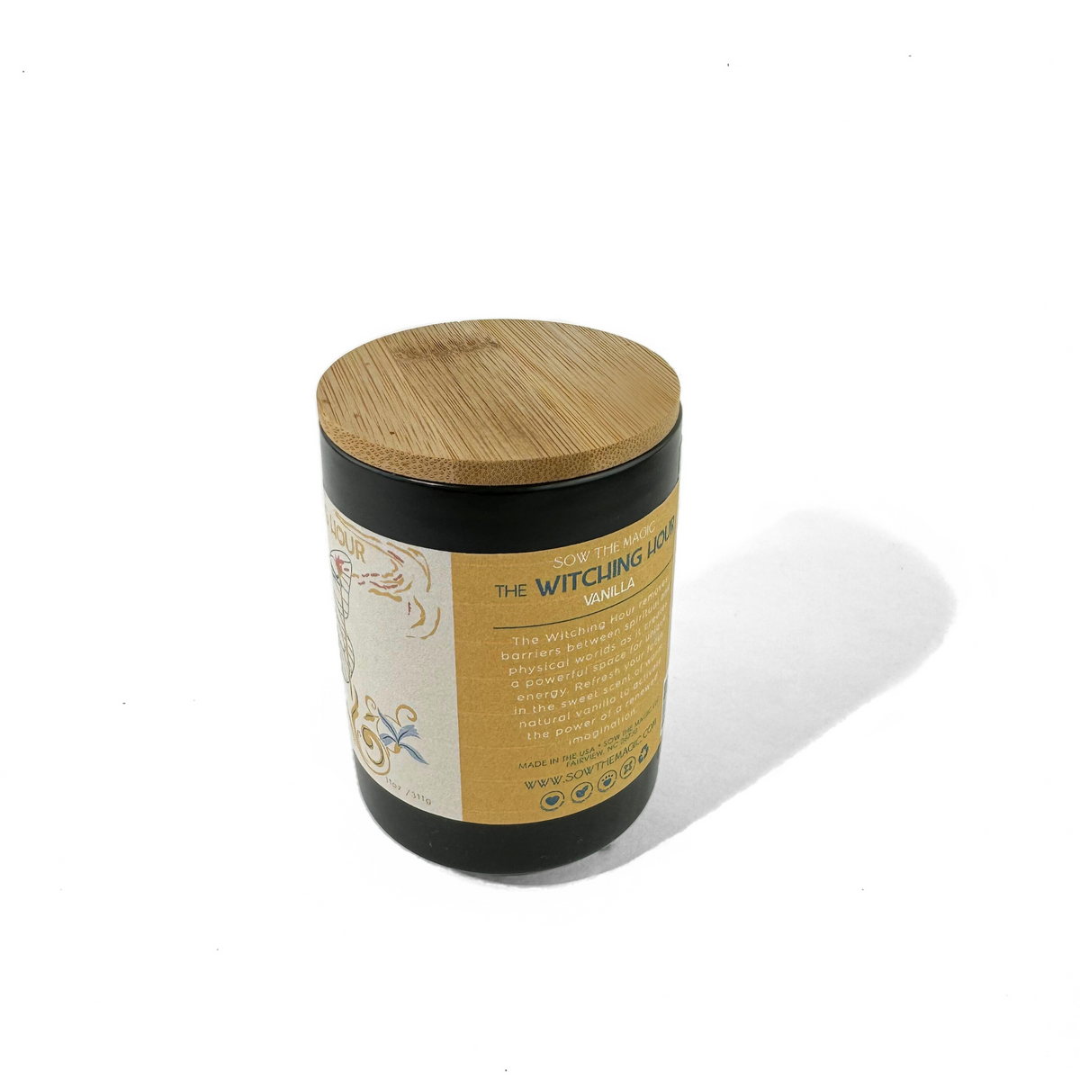 Side view of The Witching Hour Vanilla candle with bamboo lid and wraparound cream label
