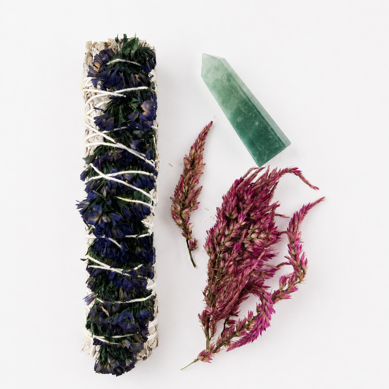 White sage bundle shown with a fluorite crystal point and loose magenta celosia flowers