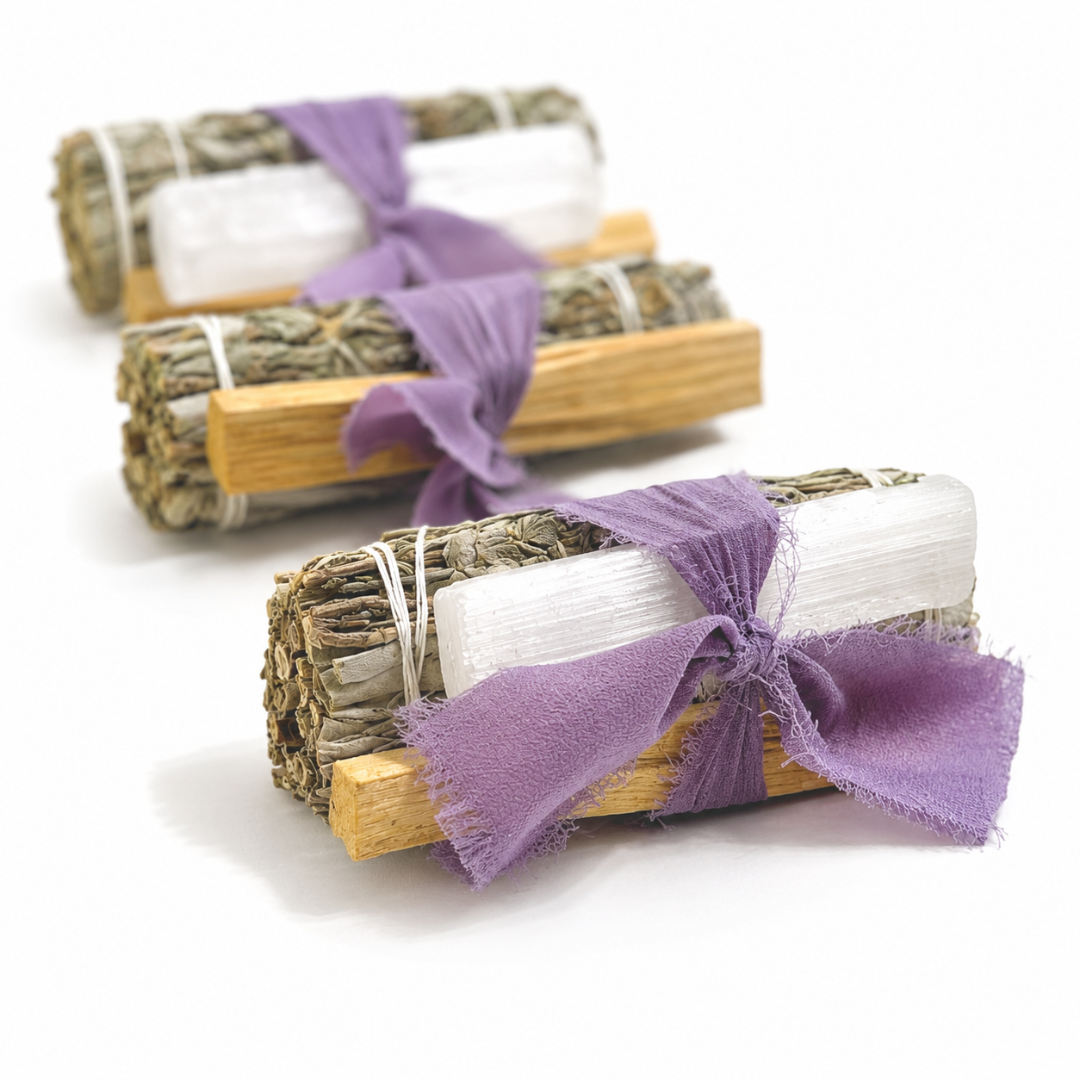 Three handcrafted White Sage Protection Ritual Bundles featuring White Sage, genuine Selenite cleansing wands, Palo Santo sticks and soft lavender ribbons displayed on a bright white background. Handmade spiritual gift sets by Sow the Magic®