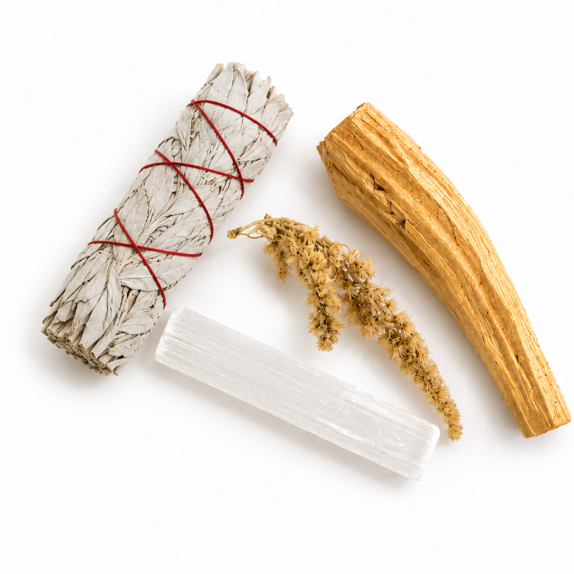 Flat lay of a white sage smudge stick, palo santo stick, selenite crystal and dried goldenrod arranged on a white background for a natural energy cleansing ritual.