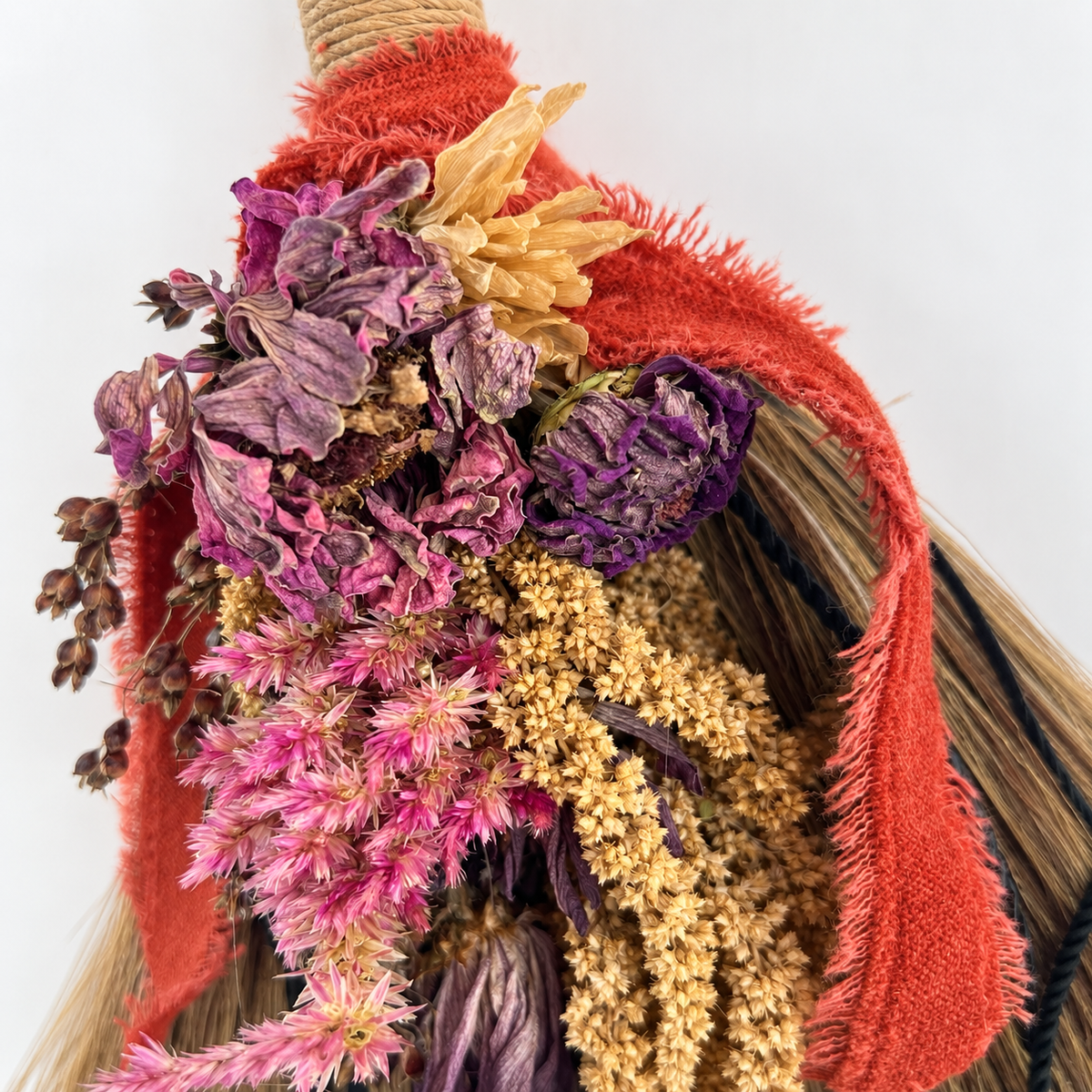 Close-up of farm-grown dried flowers and botanicals decorating the handmade Wildheart Botanical Broom