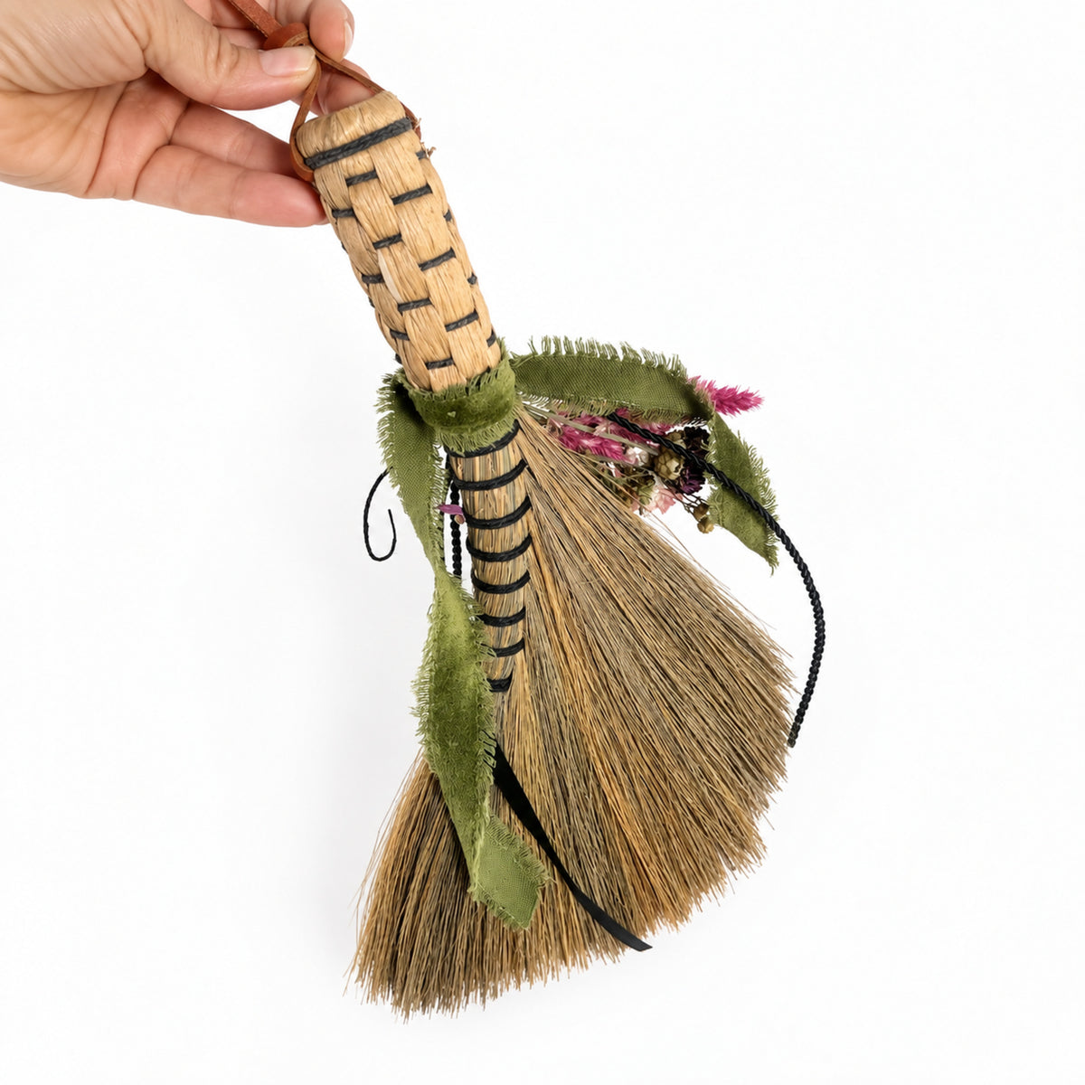 Side view of the Wildheart Botanical Broom showing its woven handle and botanical embellishments