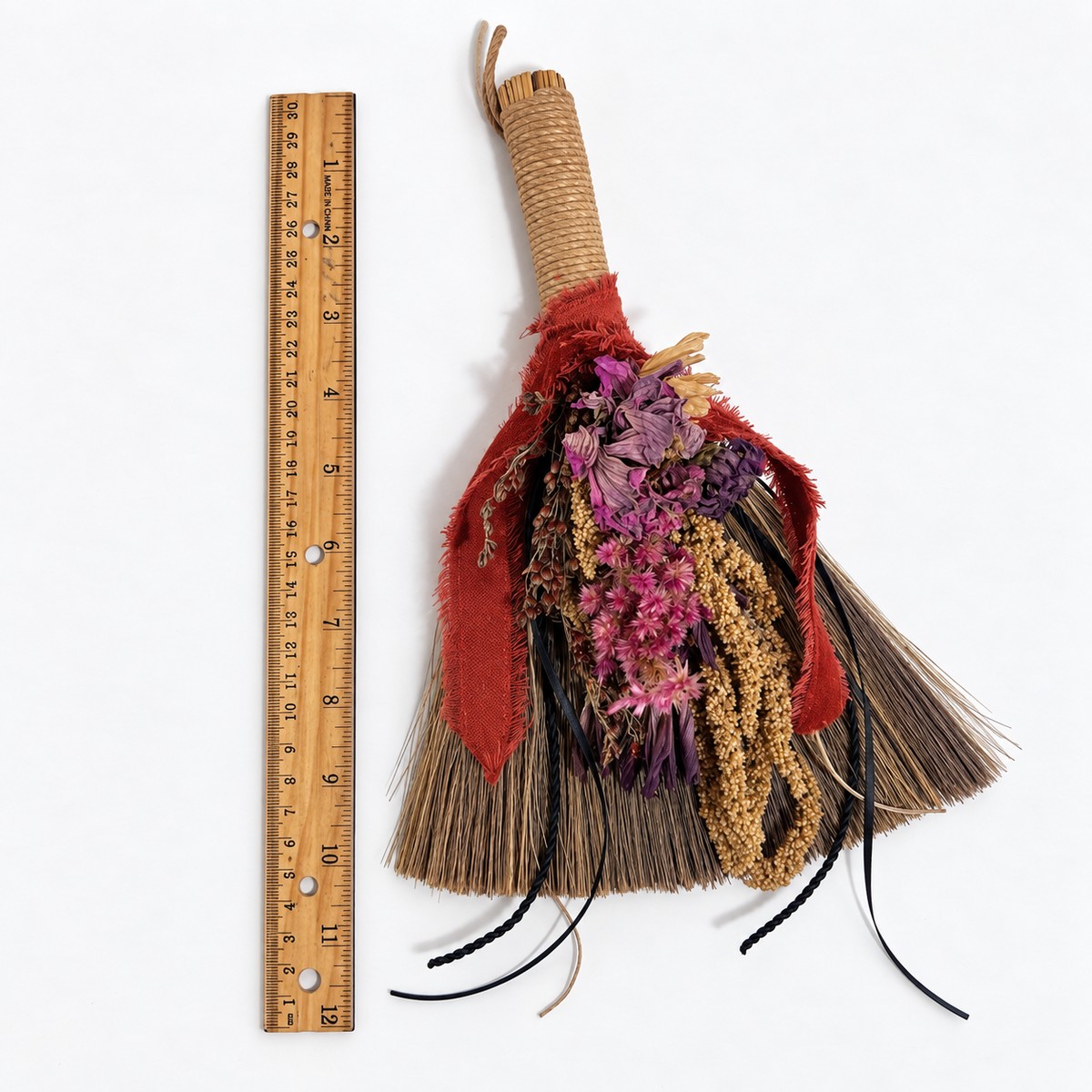 Wildheart Botanical Broom shown beside a ruler to demonstrate the approximate height of the handmade decorative broom