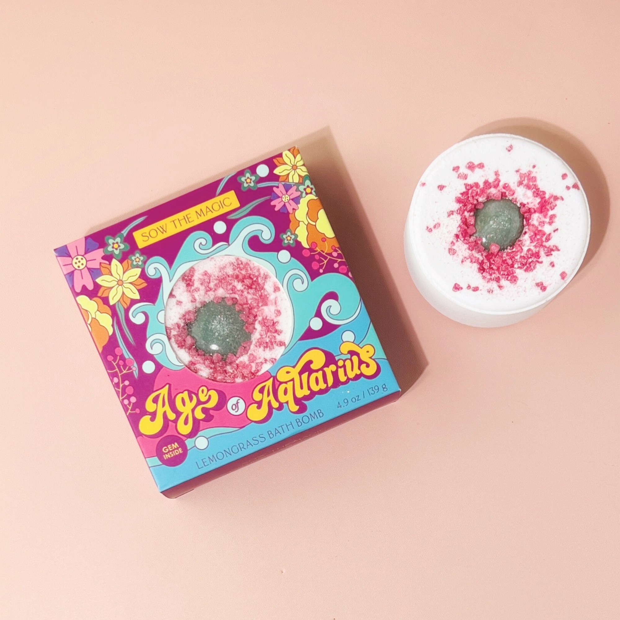 Age of Aquarius Lemongrass Bath Bomb with aventurine gemstone shown on soft pink background