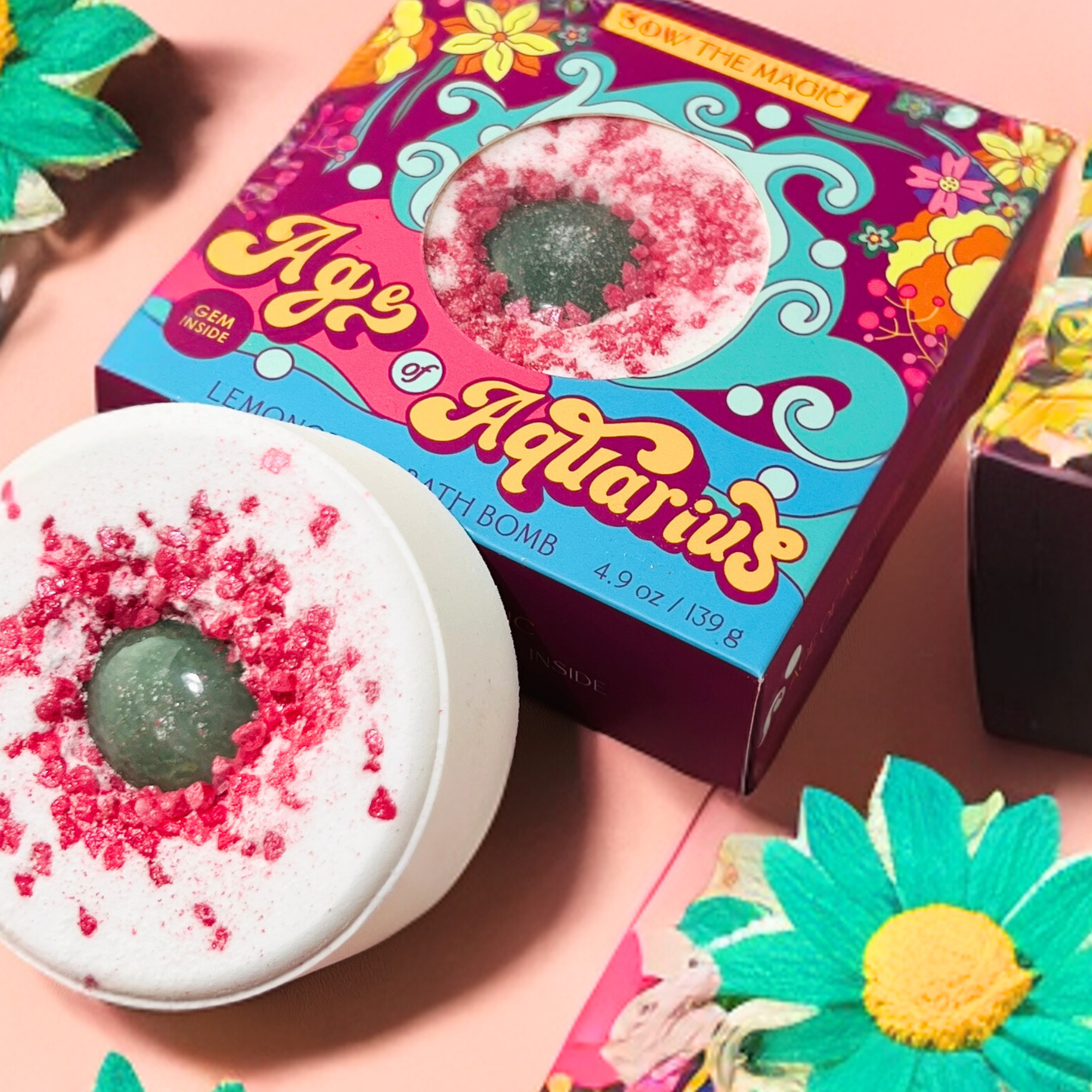 Colorful Age of Aquarius Lemongrass Bath Bomb styled with green and yellow flowers for spring theme