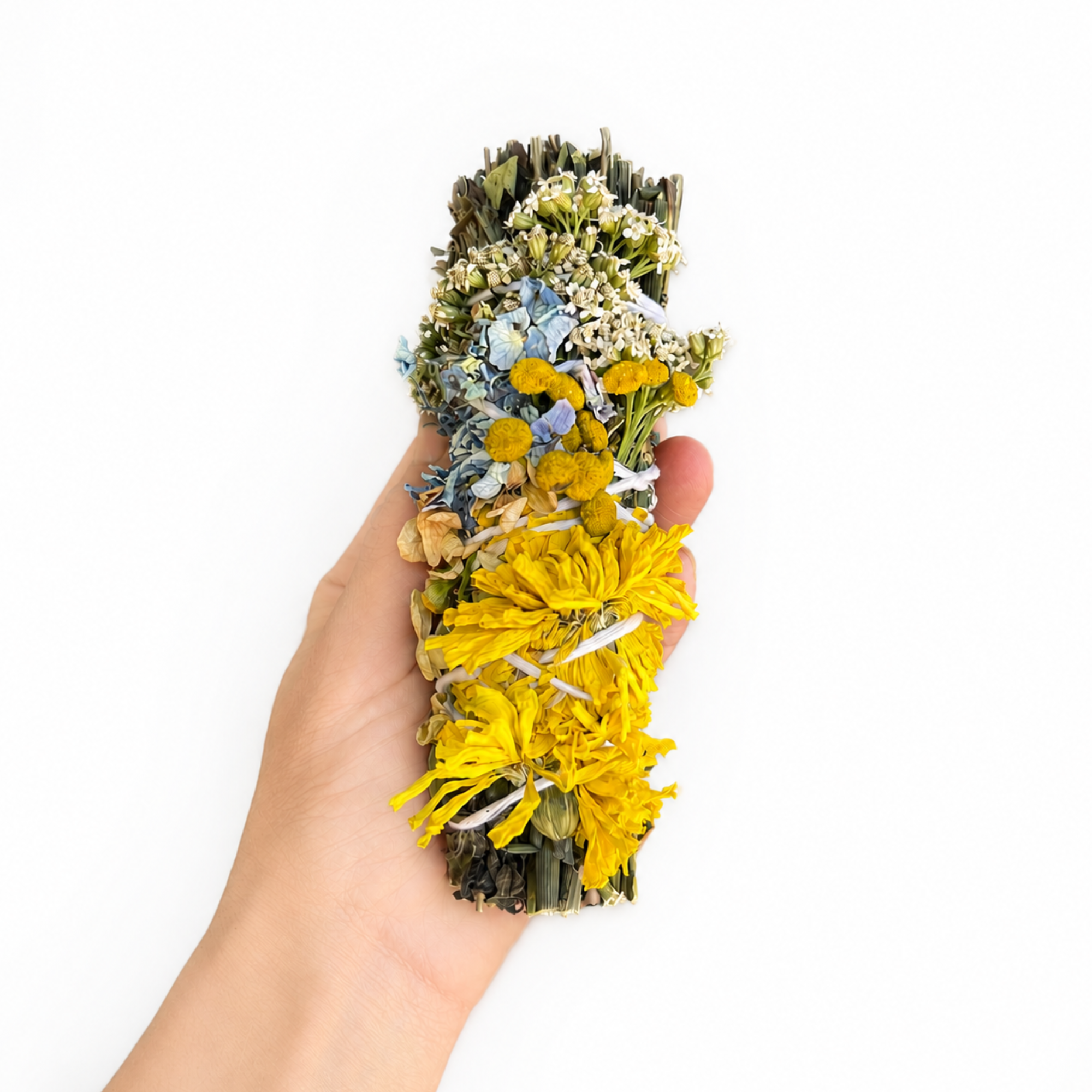 Hand holding a botanical herbal wafting wand wrapped with bright yellow, blue and purple dried flowers