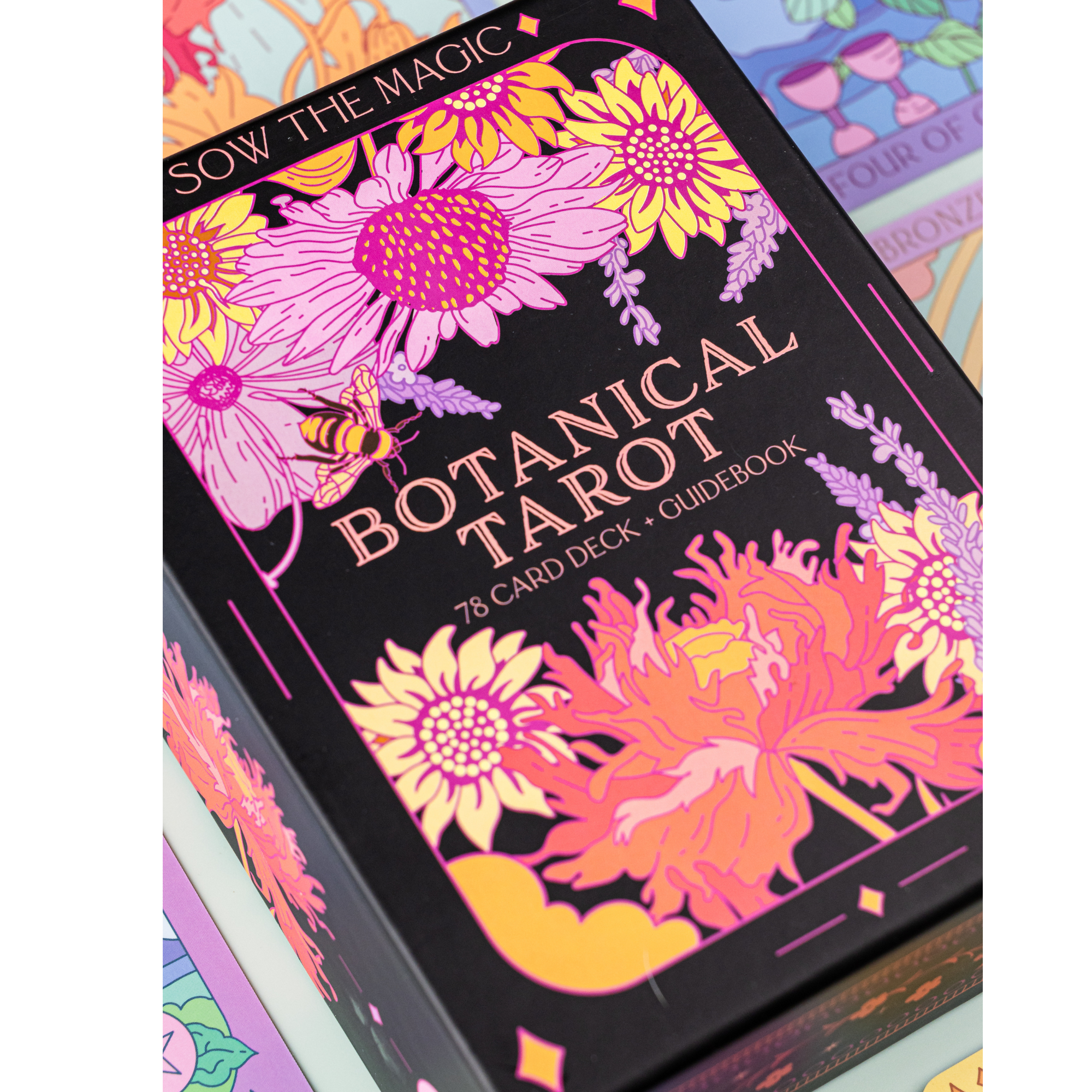 Close-up of Botanical Tarot Deck box featuring bright flower artwork and Sow the Magic branding.