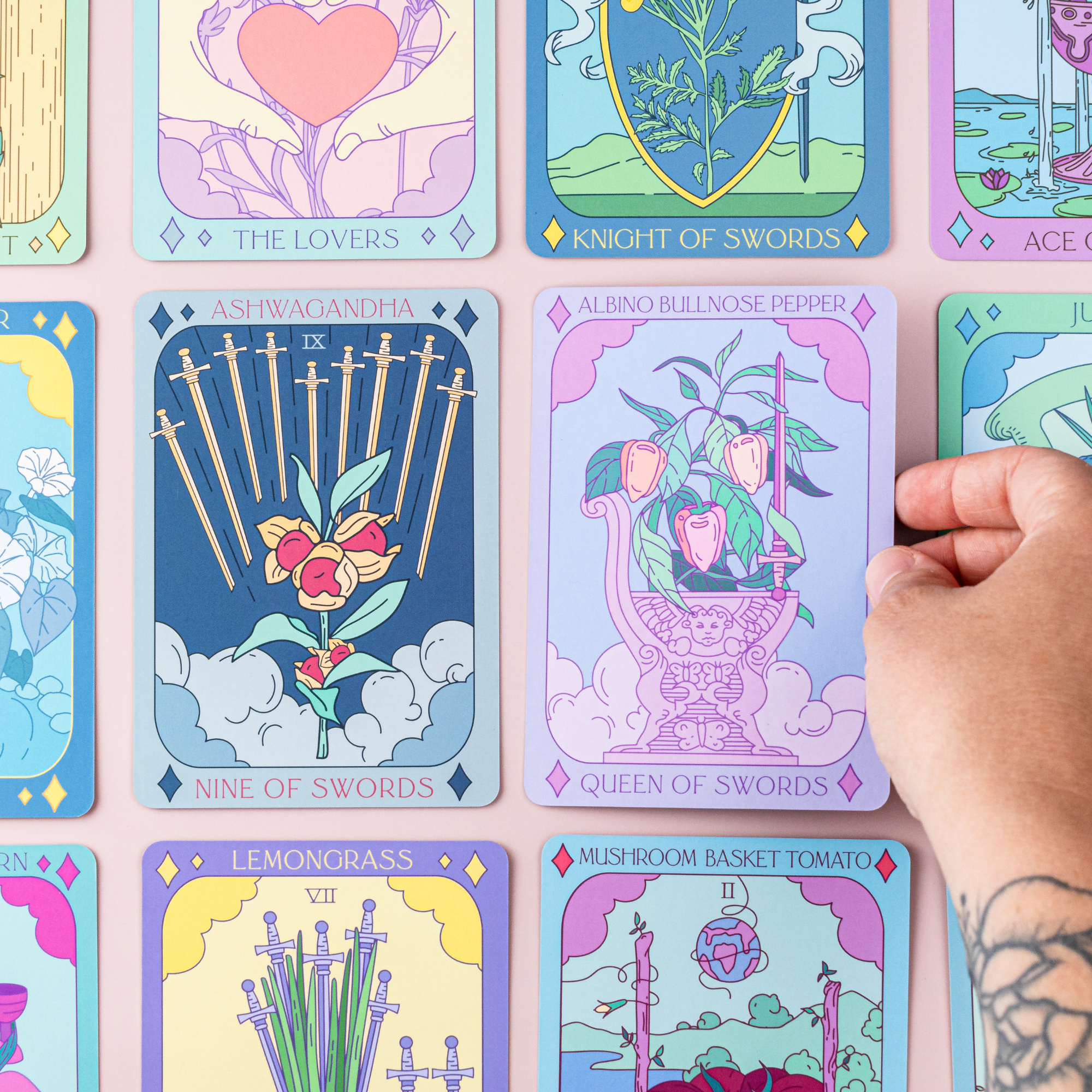 Hand selecting Botanical Tarot card with vibrant floral illustrations and plant-inspired symbolism from the deck.