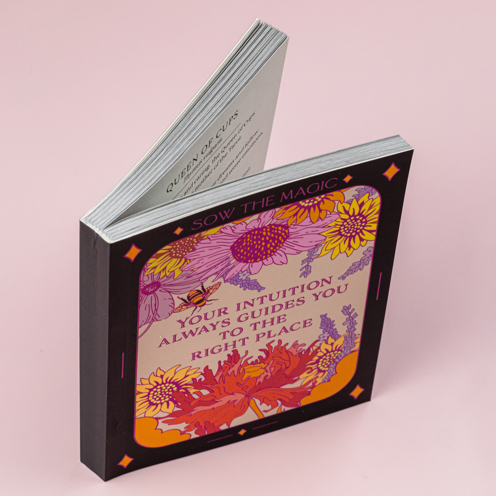 Open Botanical Tarot guidebook featuring floral cover with message “Your intuition always guides you to the right place.”