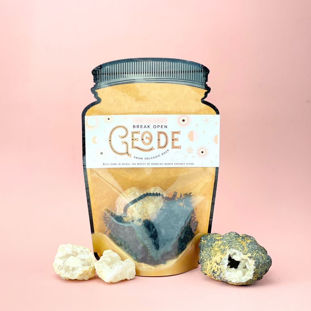 Break Open Geode Rock pouch displayed with open sparkling quartz crystals on soft pink background