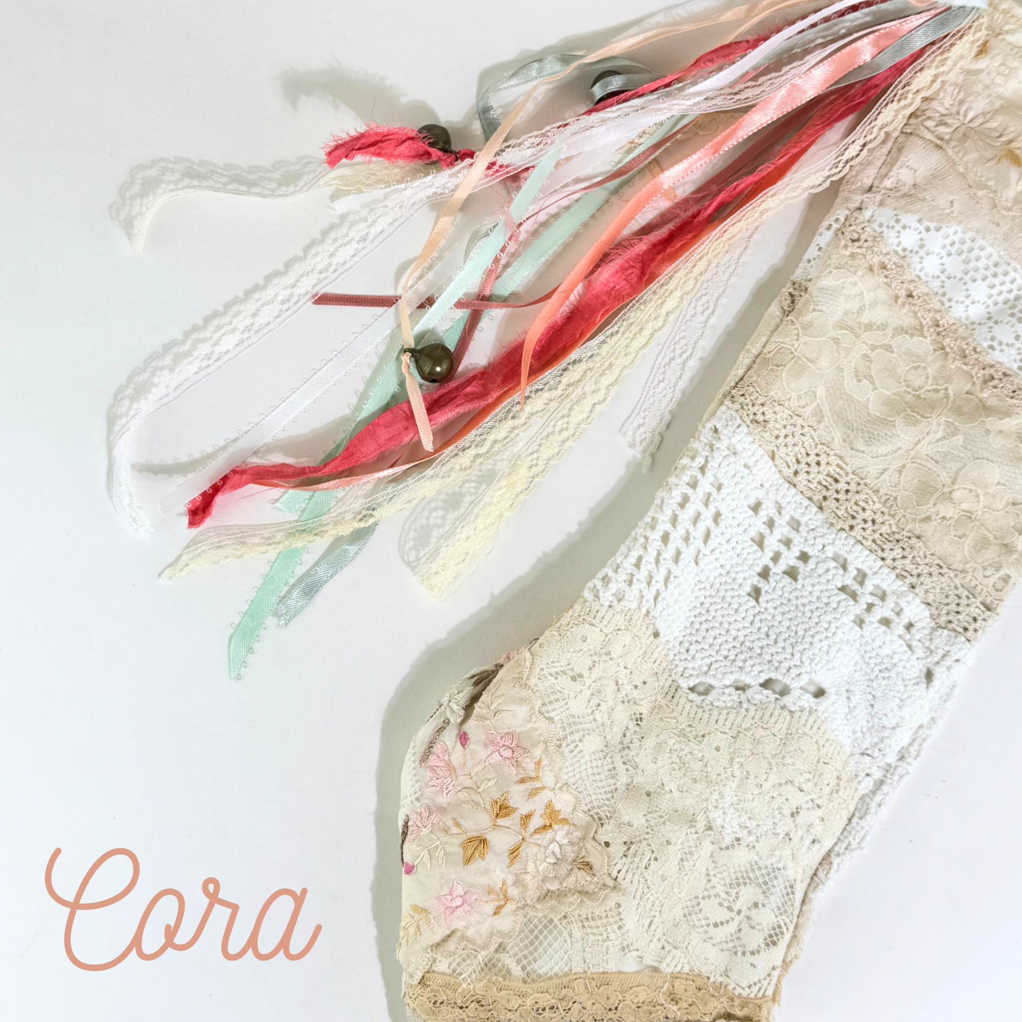 Close-up of Cora lace Christmas stocking with floral embroidery, crochet lace, and pastel tones