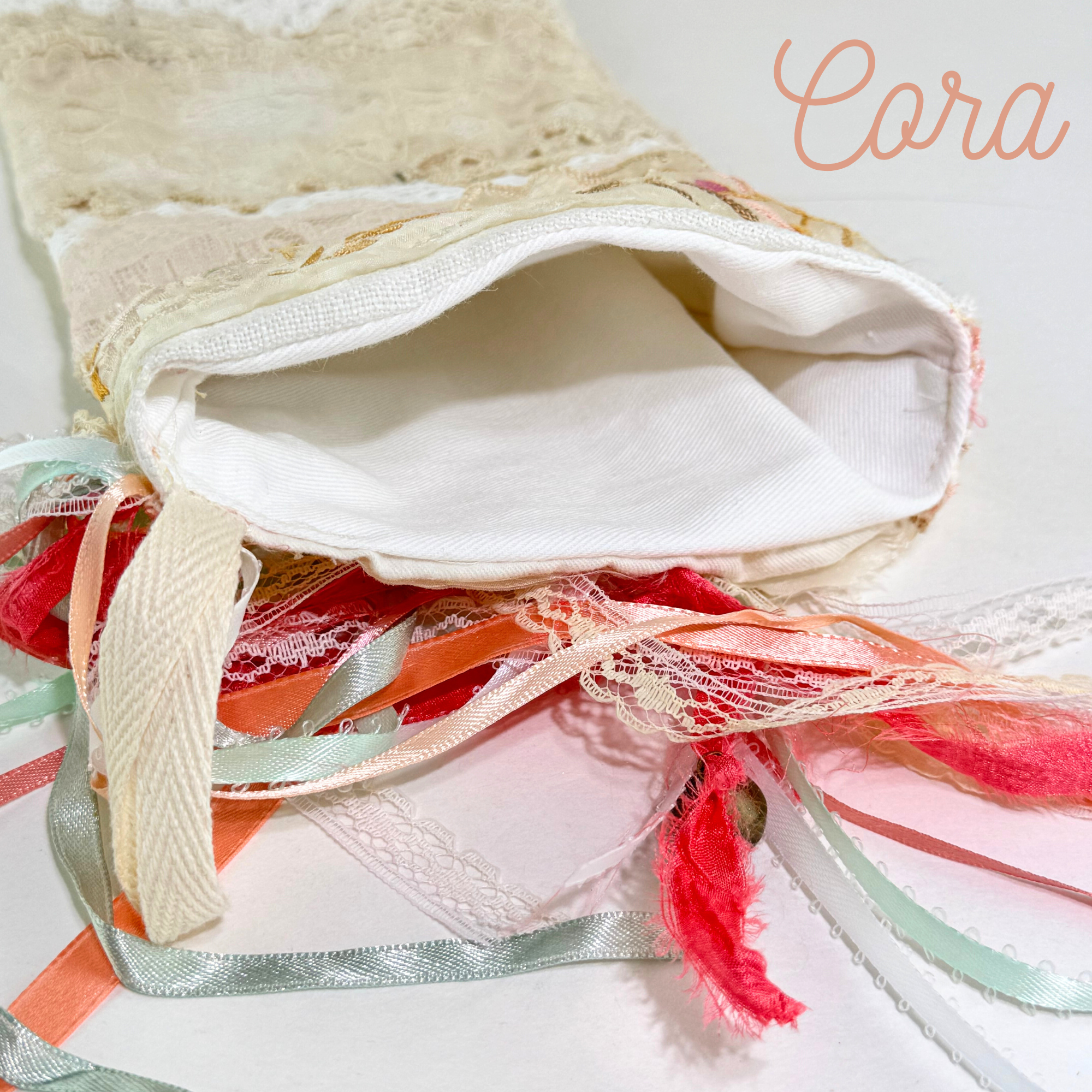 Upper section of handmade lace Christmas stocking with embroidered florals and vintage ribbon tassels