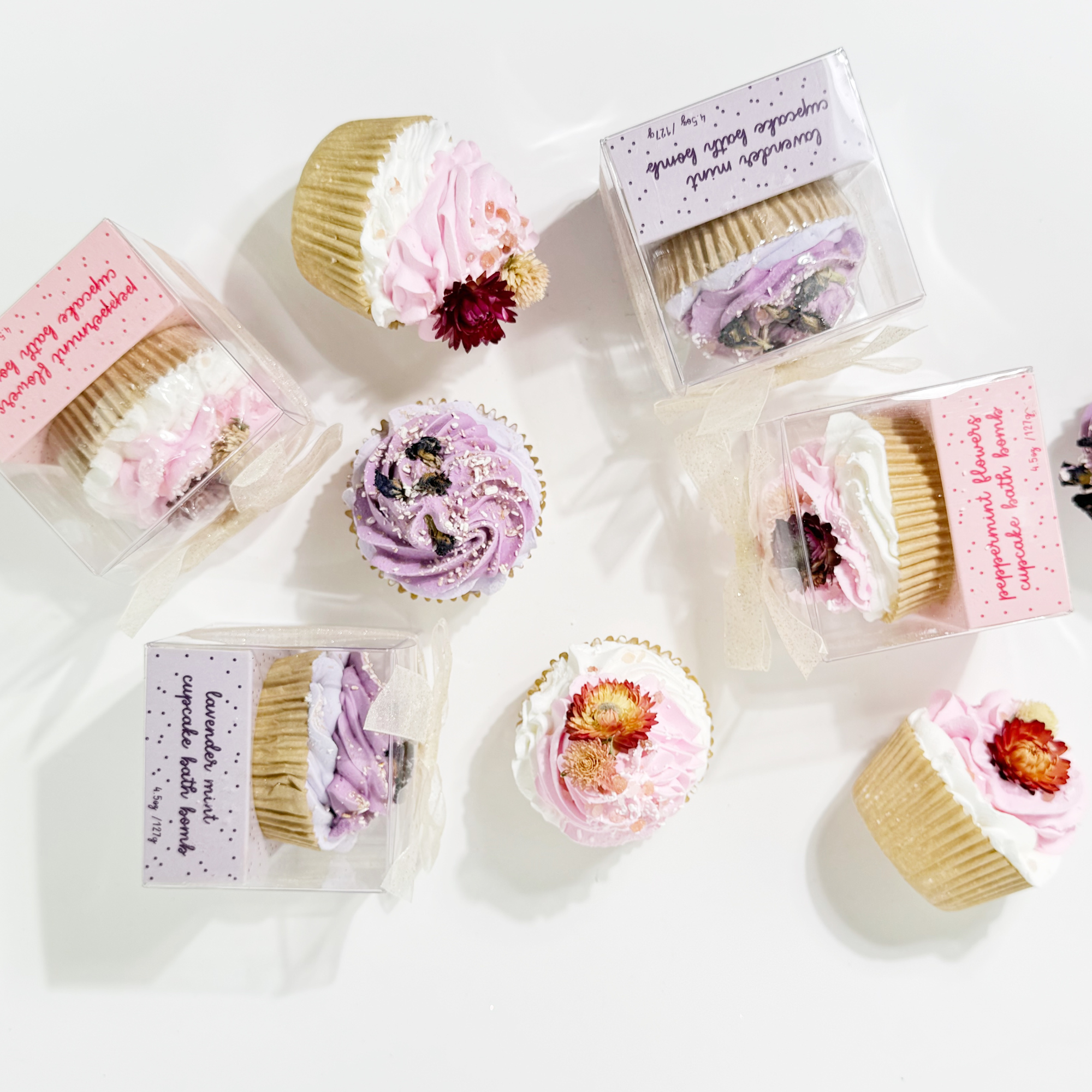 Overhead view of Lavender Mint and Peppermint Flowers Cupcake Bath Bombs in clear gift boxes with bows