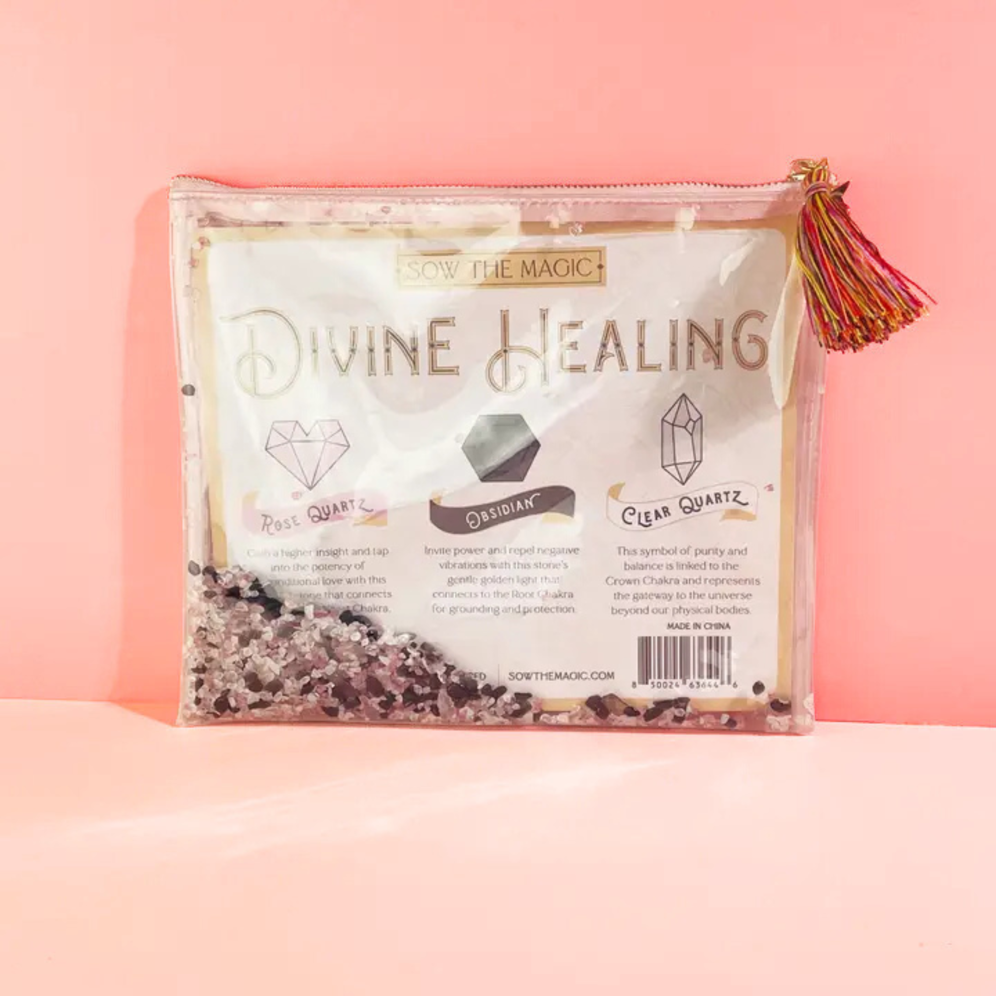 Divine Healing Gemstone Cosmetic Bag with Rose Quartz, Obsidian, and Clear Quartz on pink background