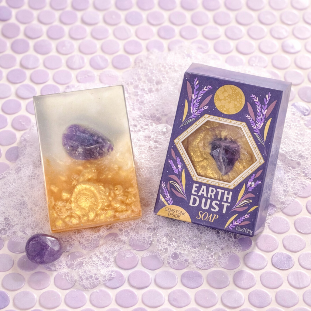 Earth Dust gemstone soap with amethyst on pastel purple penny tile with soft suds and tumbled amethyst stone