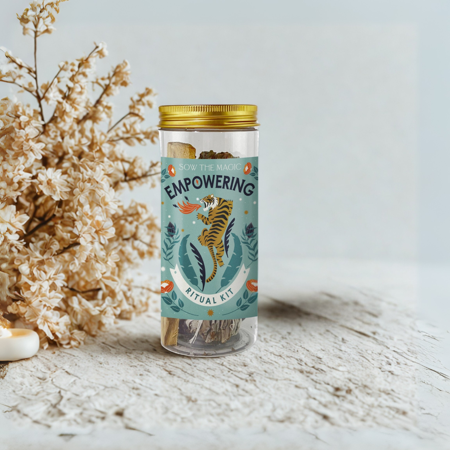 Empowering Ritual Kit displayed beside dried flowers and candles for spiritual cleansing and sacred space rituals
