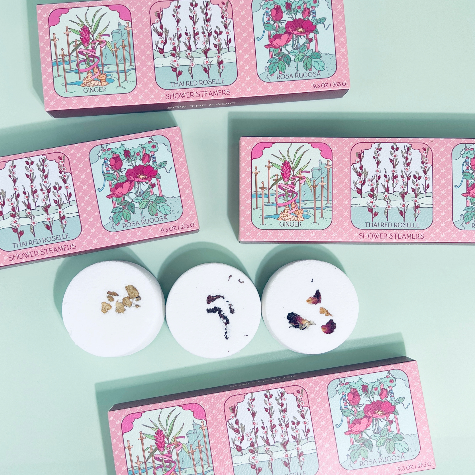 Three Floral Tarot Shower Steamers with visible botanicals shown next to illustrated tarot-inspired box