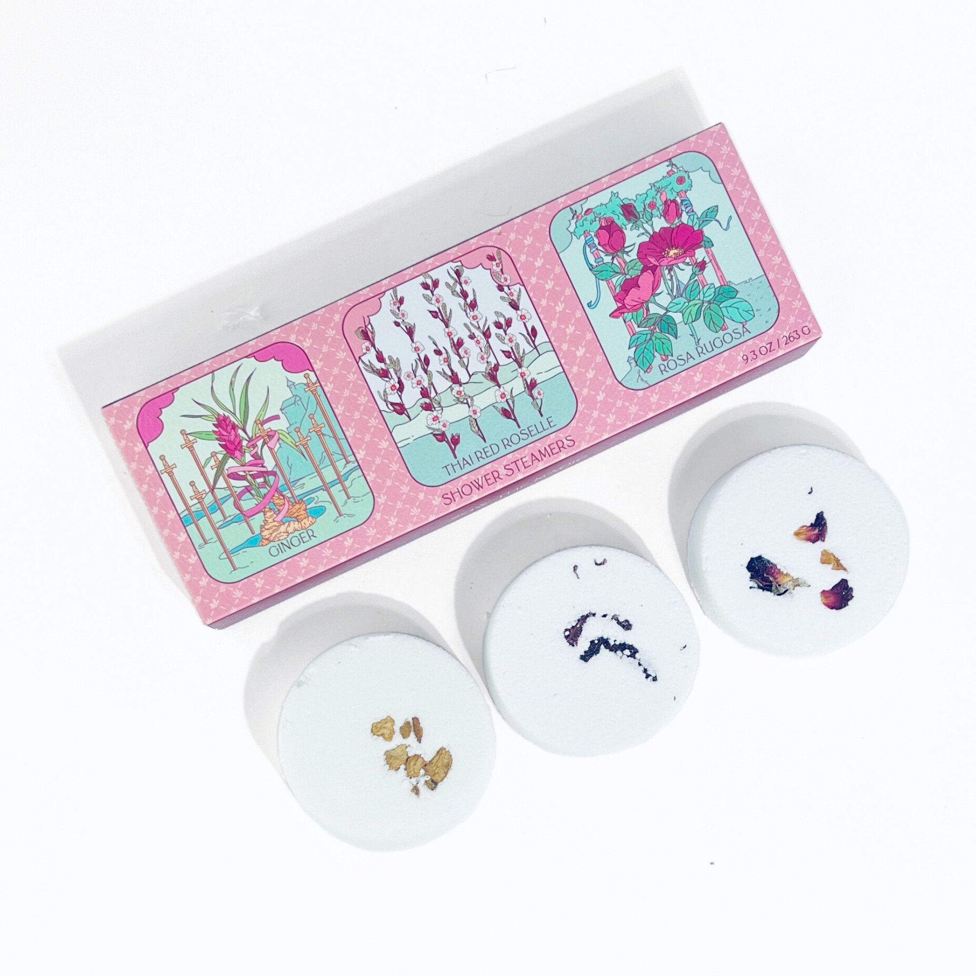 Floral Tarot Shower Steamer Trio with Ginger, Rose, and Thai Red Roselle botanicals displayed beside packaging