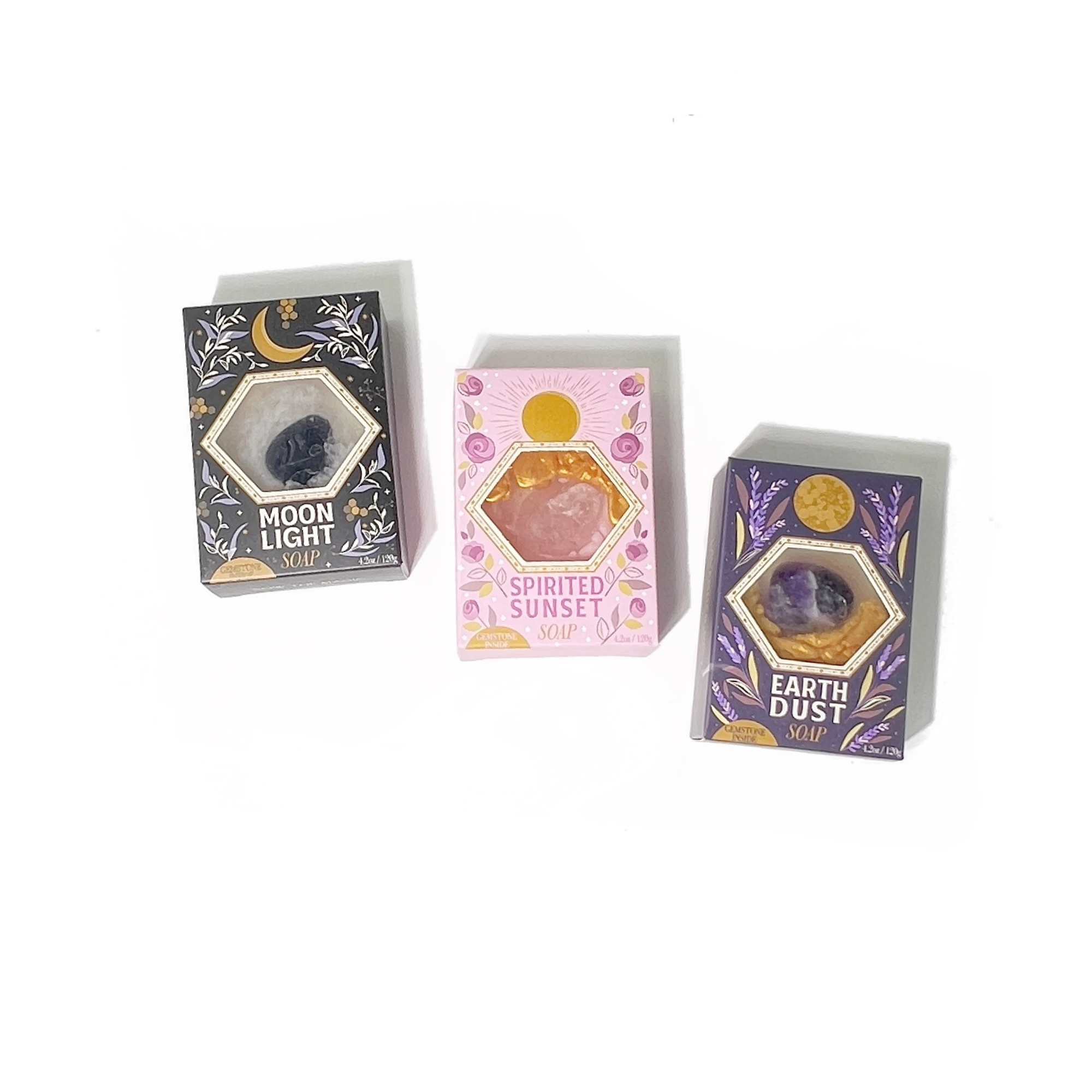 Collection of Moonlight, Spirited Sunset, and Earth Dust Gemstone Soaps displayed together on white background.