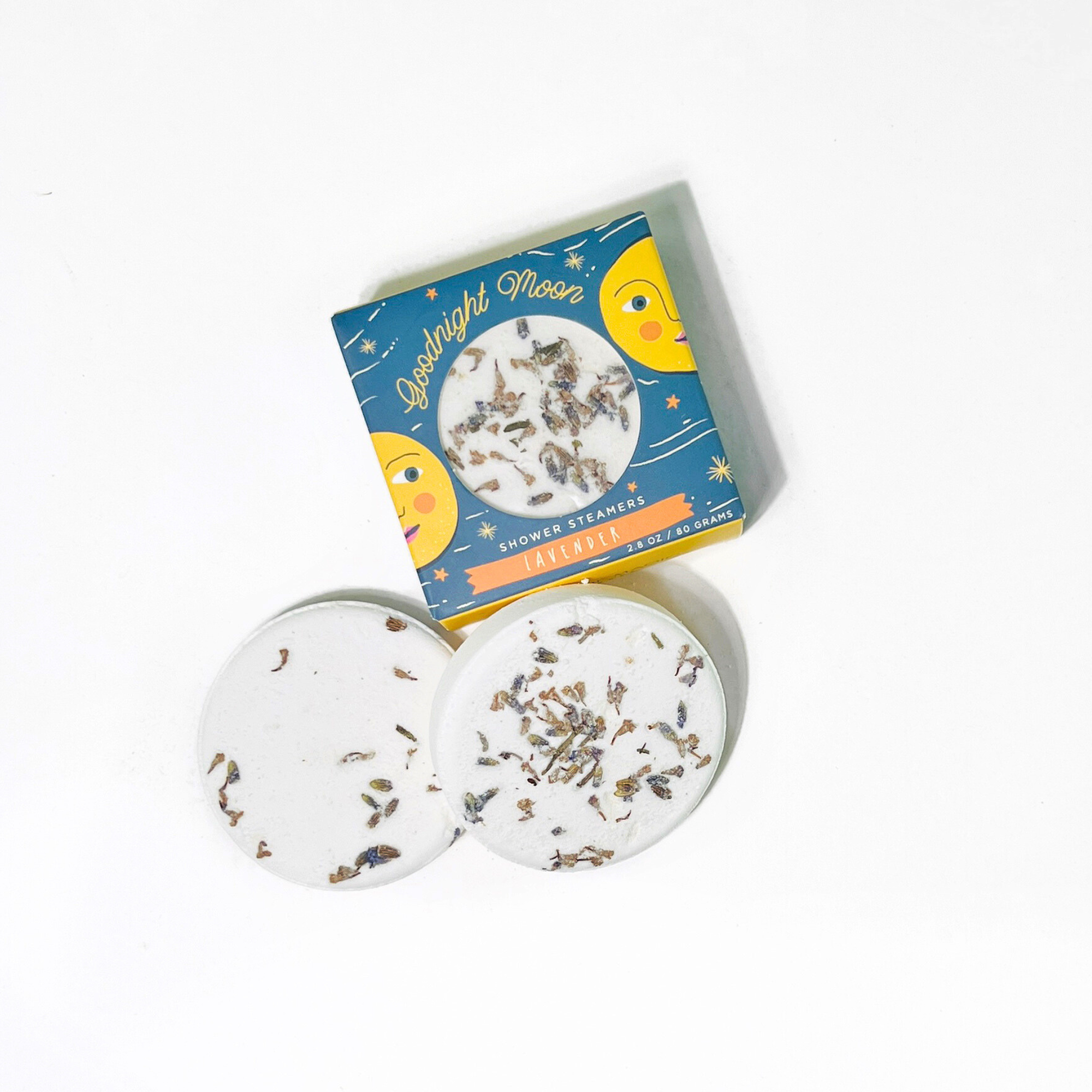Two lavender shower steamers with dried lavender petals beside Goodnight Moon box by Sow the Magic