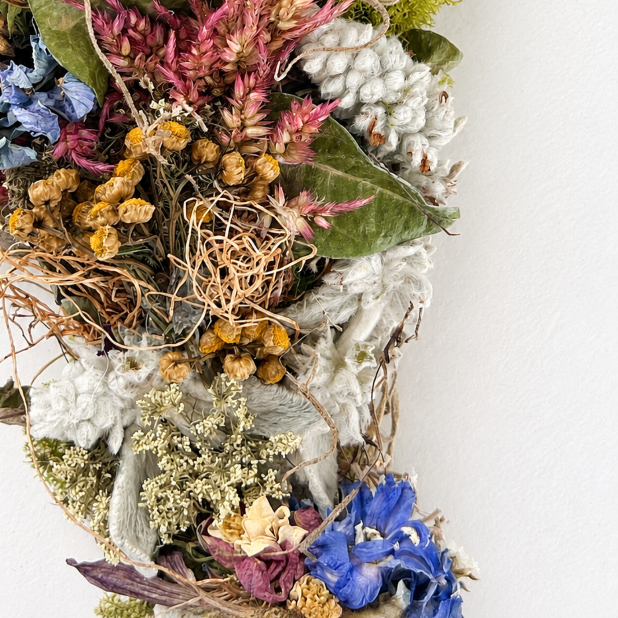 Close-up of dried flowers, textured foliage and natural materials in a handmade botanical decoration