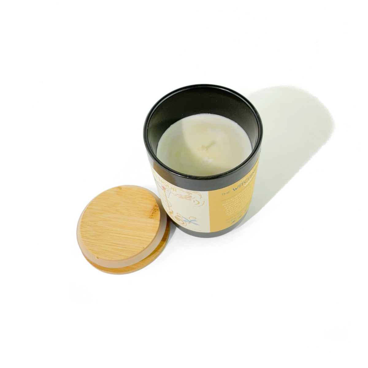 Overhead view of the open Witching Hour Vanilla candle with ivory wax, cotton wick and bamboo lid