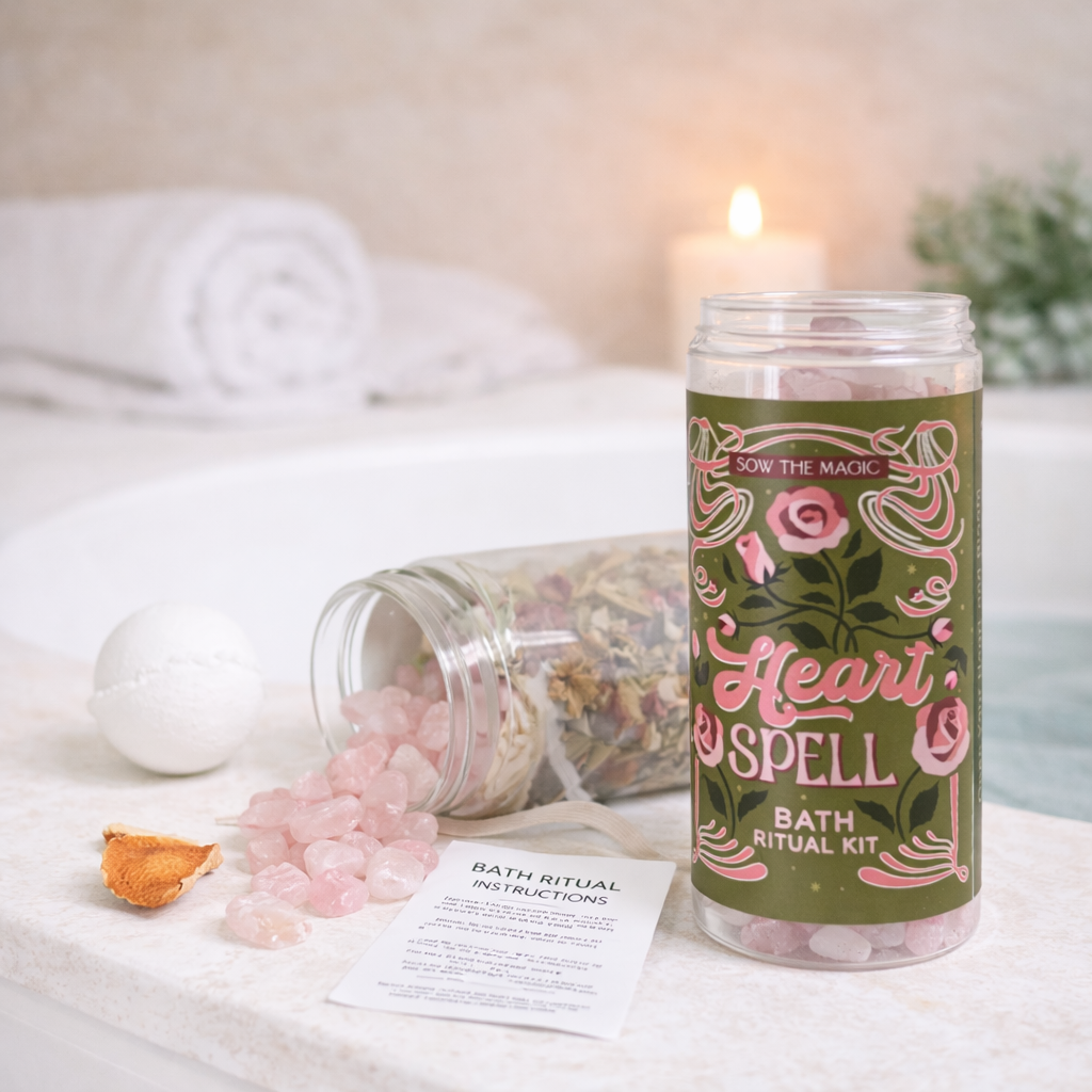 Heart Spell Bath Ritual Kit styled in a spa setting with rose quartz, bath bomb, botanical tea and dried citrus on tub ledge